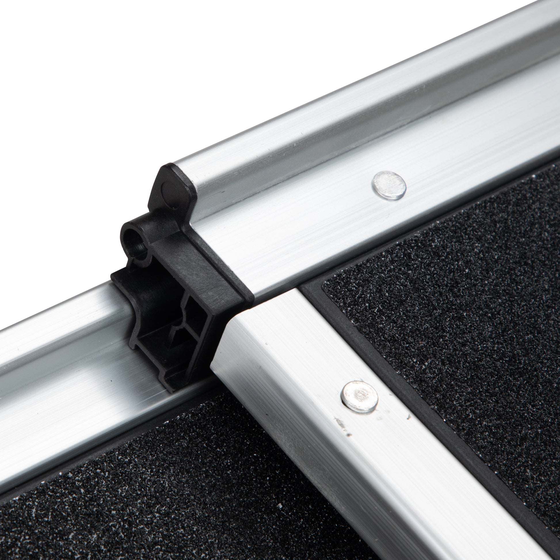 Closeup of aluminum ramp edge with black nonslip surface and connector