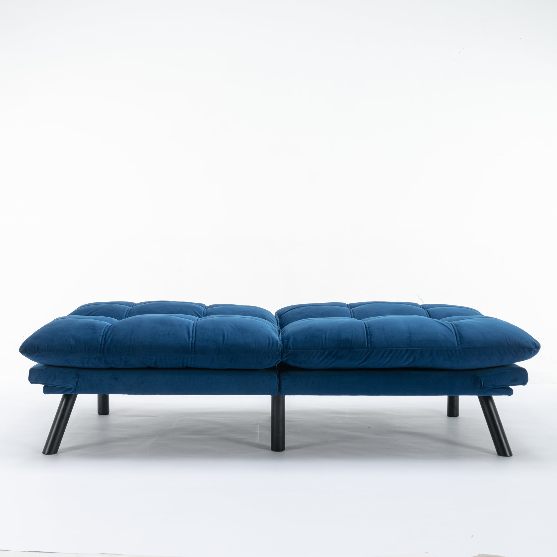 Tufted navy blue velvet futon with modern black legs perfect for small spaces