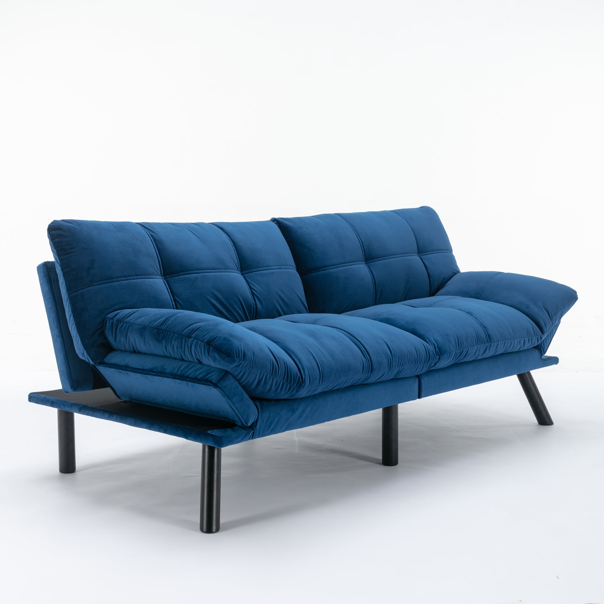 Plush navy blue velvet futon sofa with tufted cushions and black metal legs perfect for small spaces