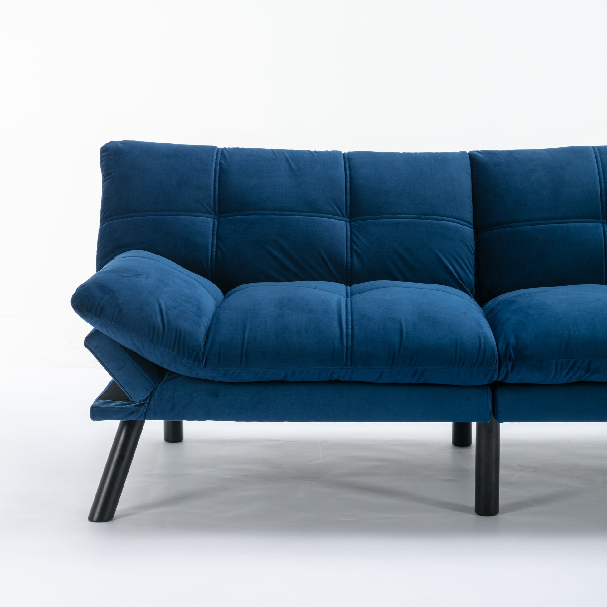 Tufted blue velvet sofa with modern black legs perfect for a living room
