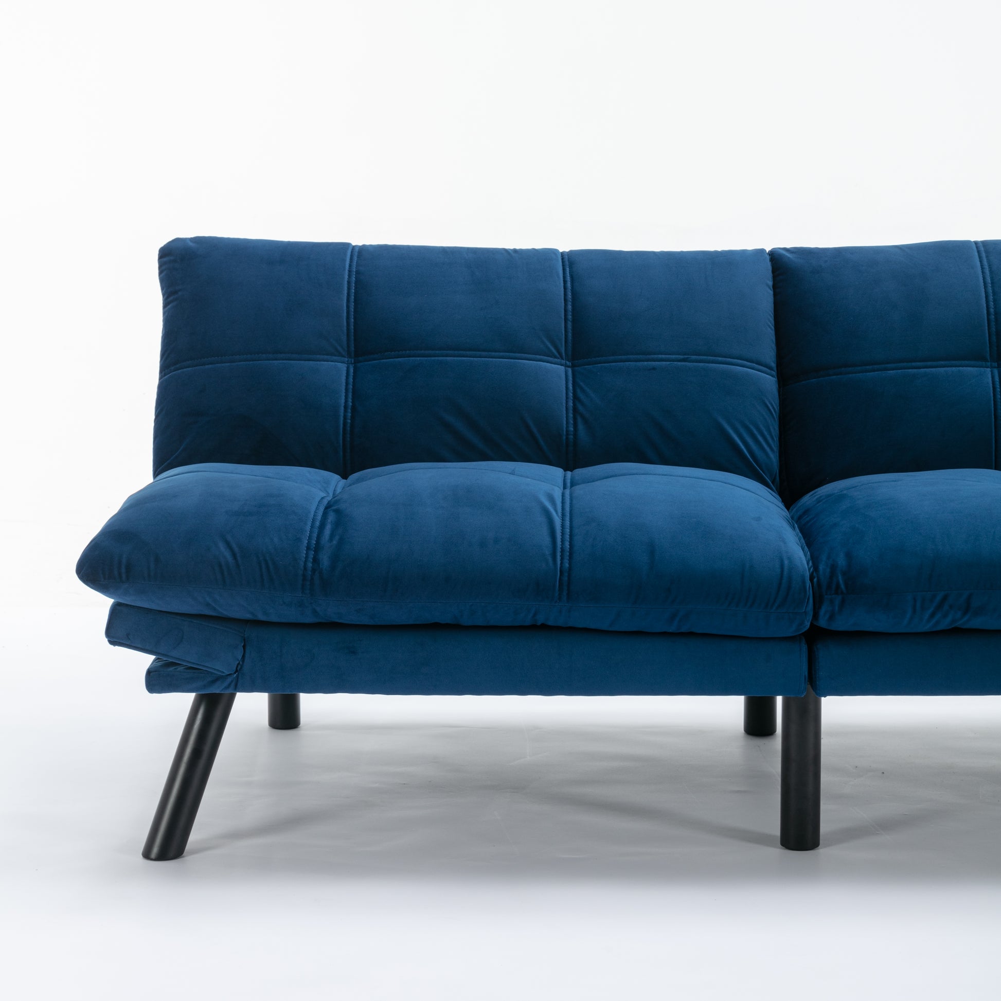 Plush navy blue velvet sofa with tufted cushions and modern black legs