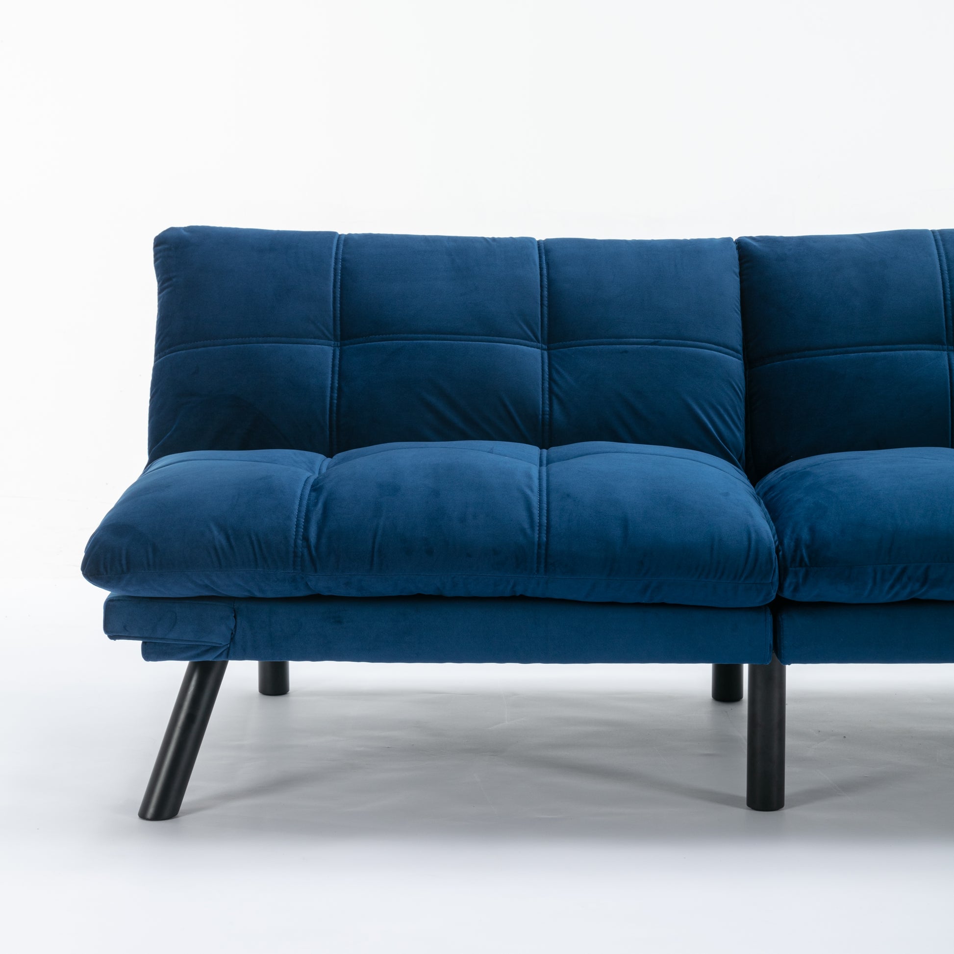 Deep blue velvet sofa with tufted back and square seat cushions on black legs