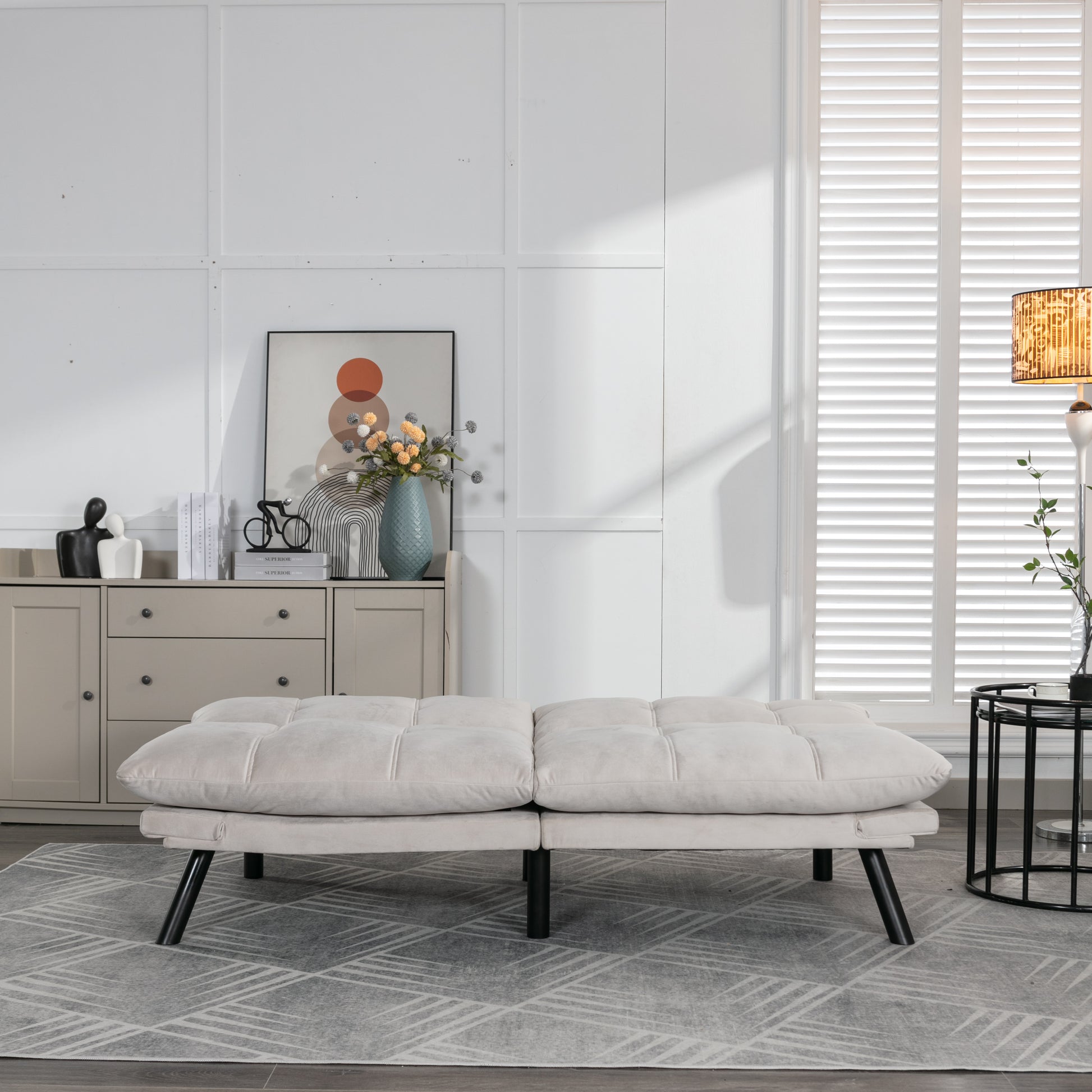 Tufted beige futon sofa with plush cushions perfect for small spaces