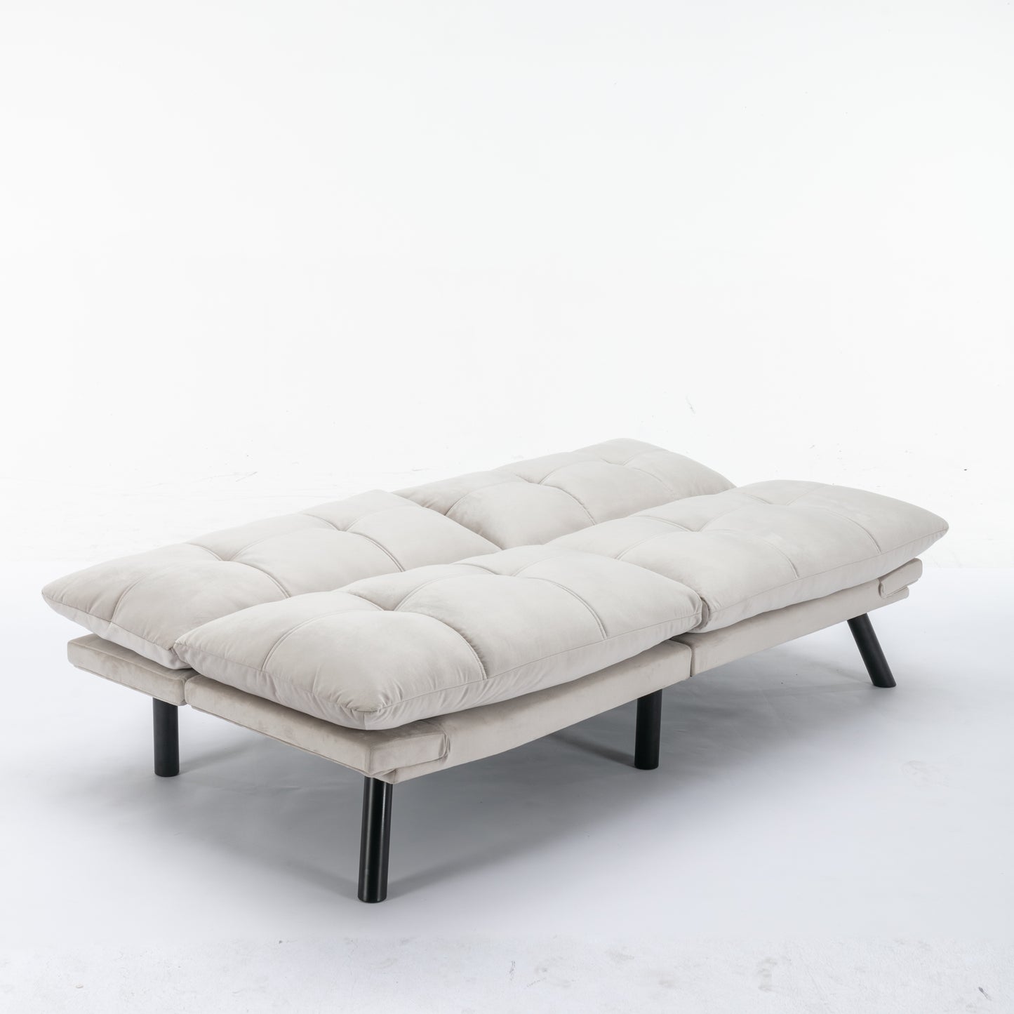 Cream velvet upholstered sofa bed with tufted cushions and black legs