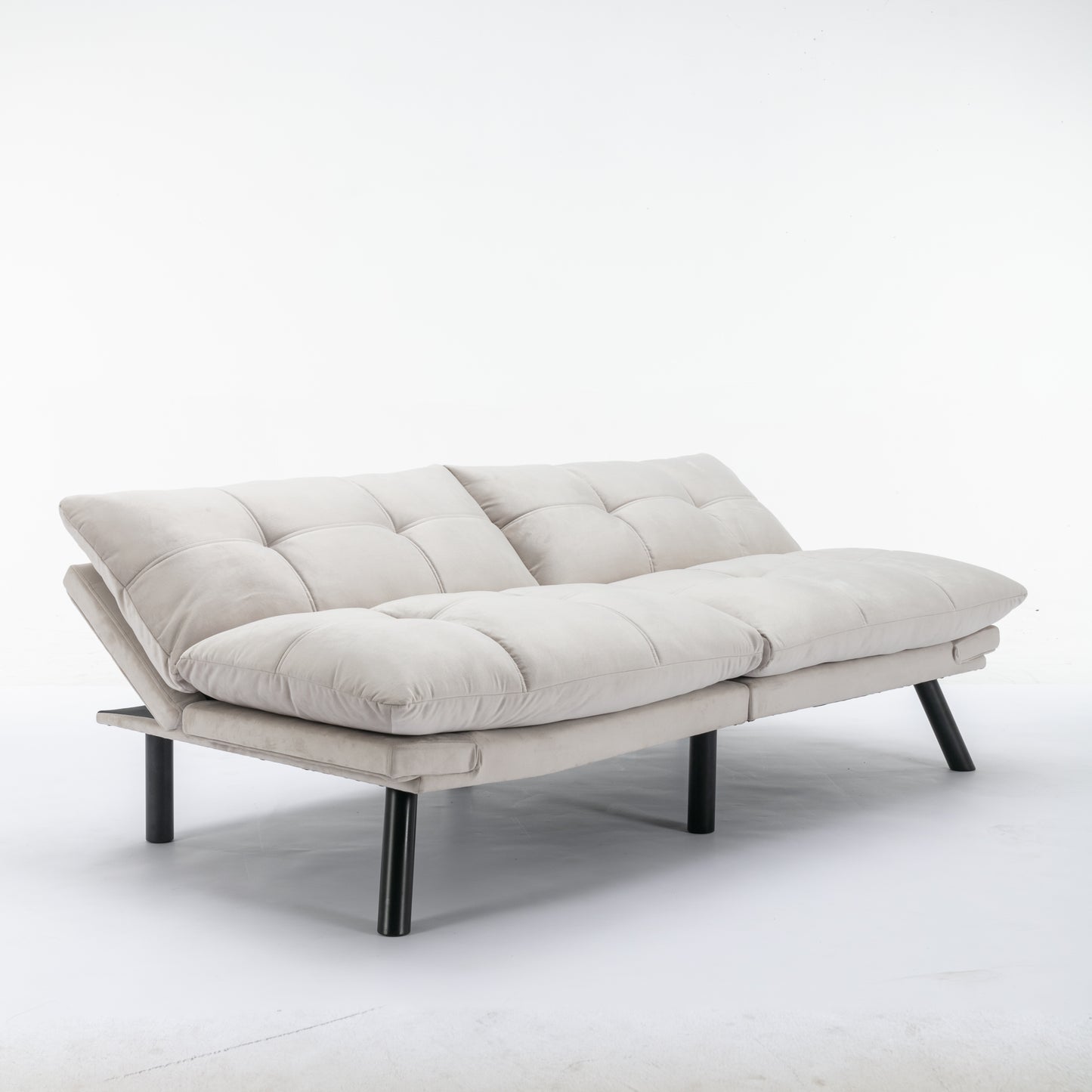 Light gray tufted futon sofa with adjustable backrest and black metal legs ideal for small spaces