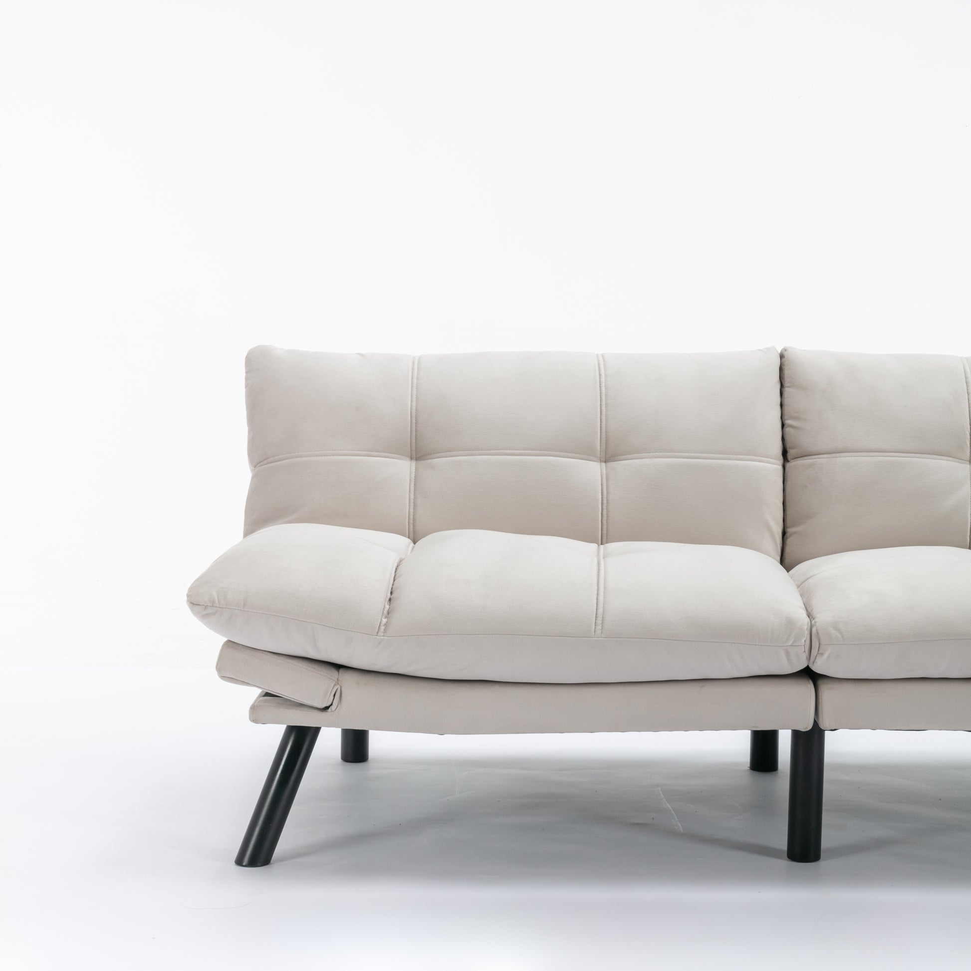 Cream tufted futon sofa with modern black legs ideal for small living spaces