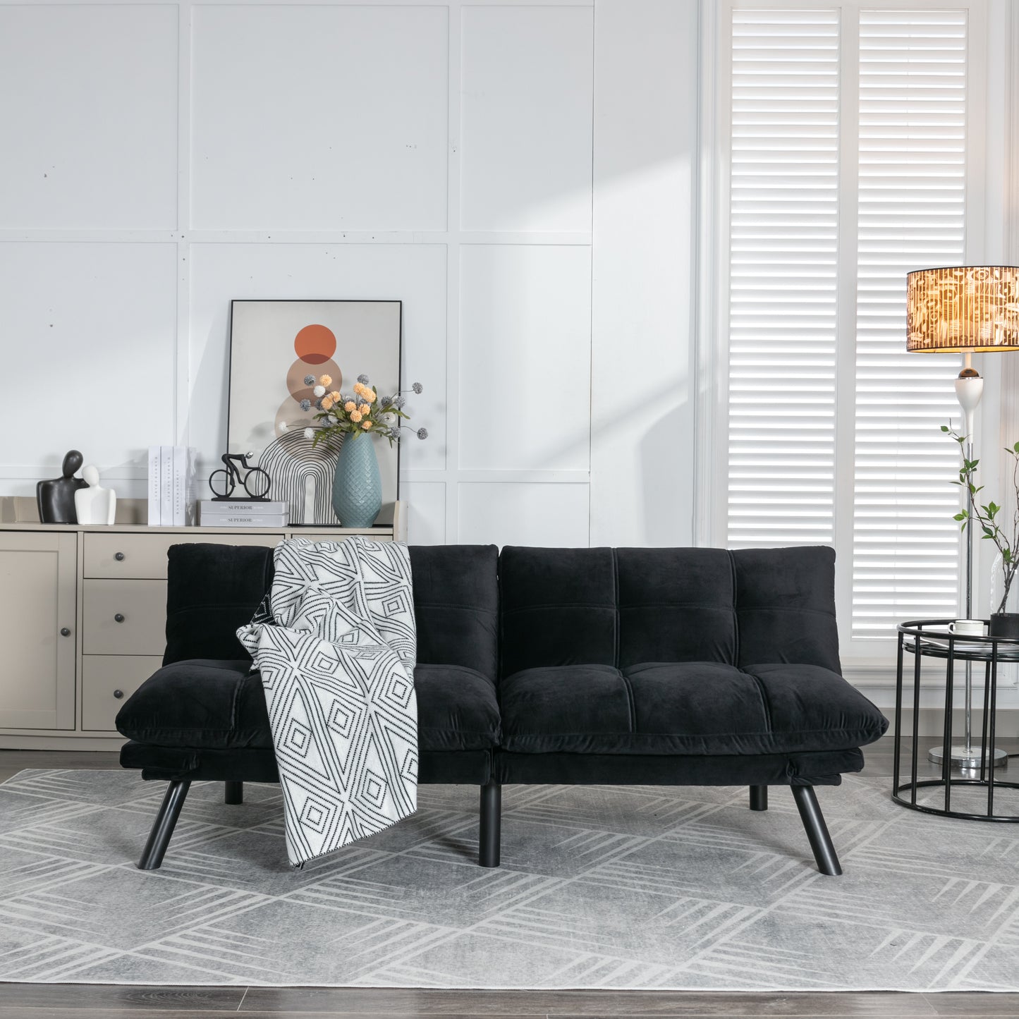 Black velvet convertible sofa bed with modern tufted design perfect for small spaces