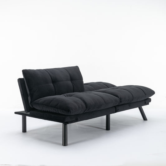 Black velvet futon couch with tufted cushions and dark metal legs