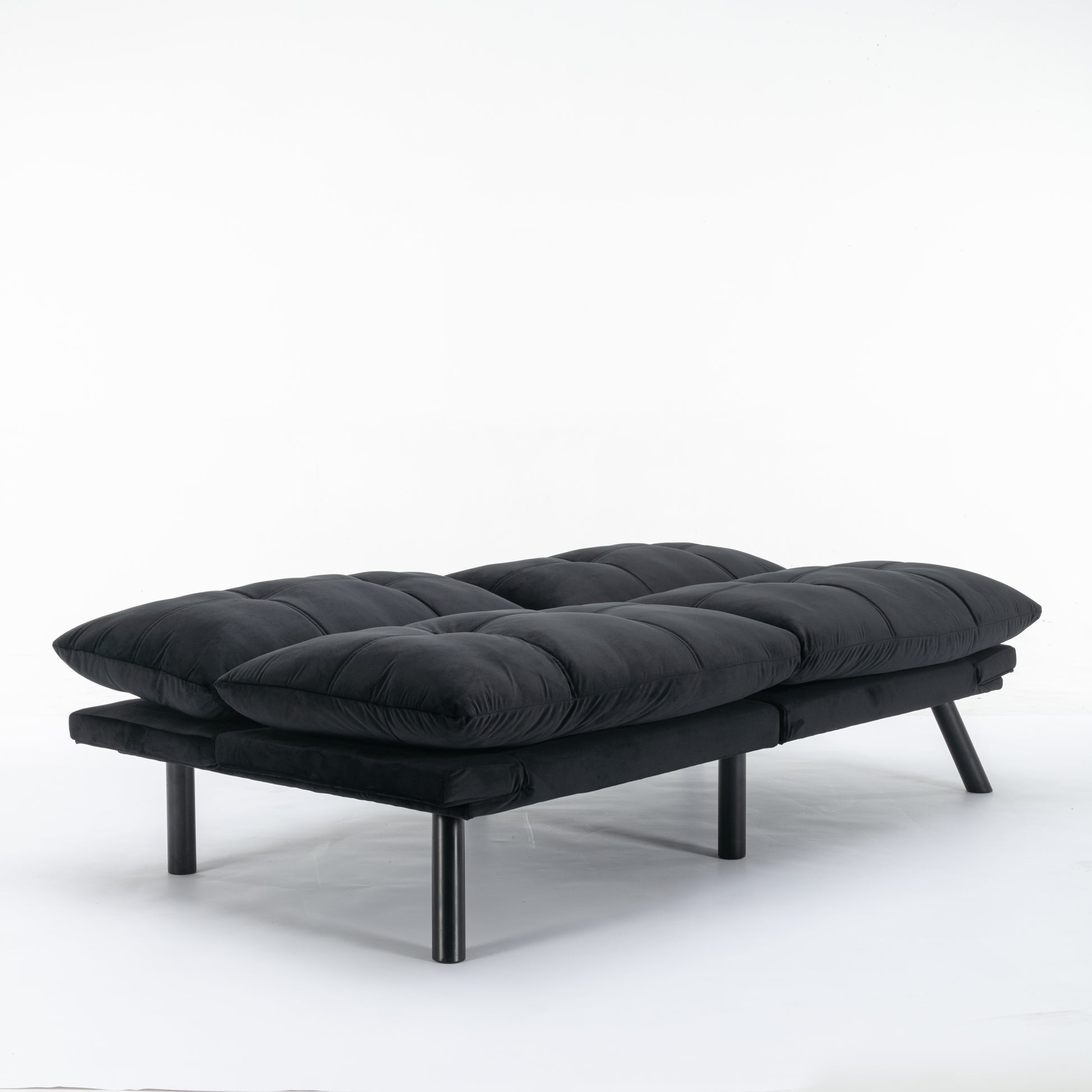 Plush black futon sofa with tufted cushions and sleek metal legs perfect for small apartments