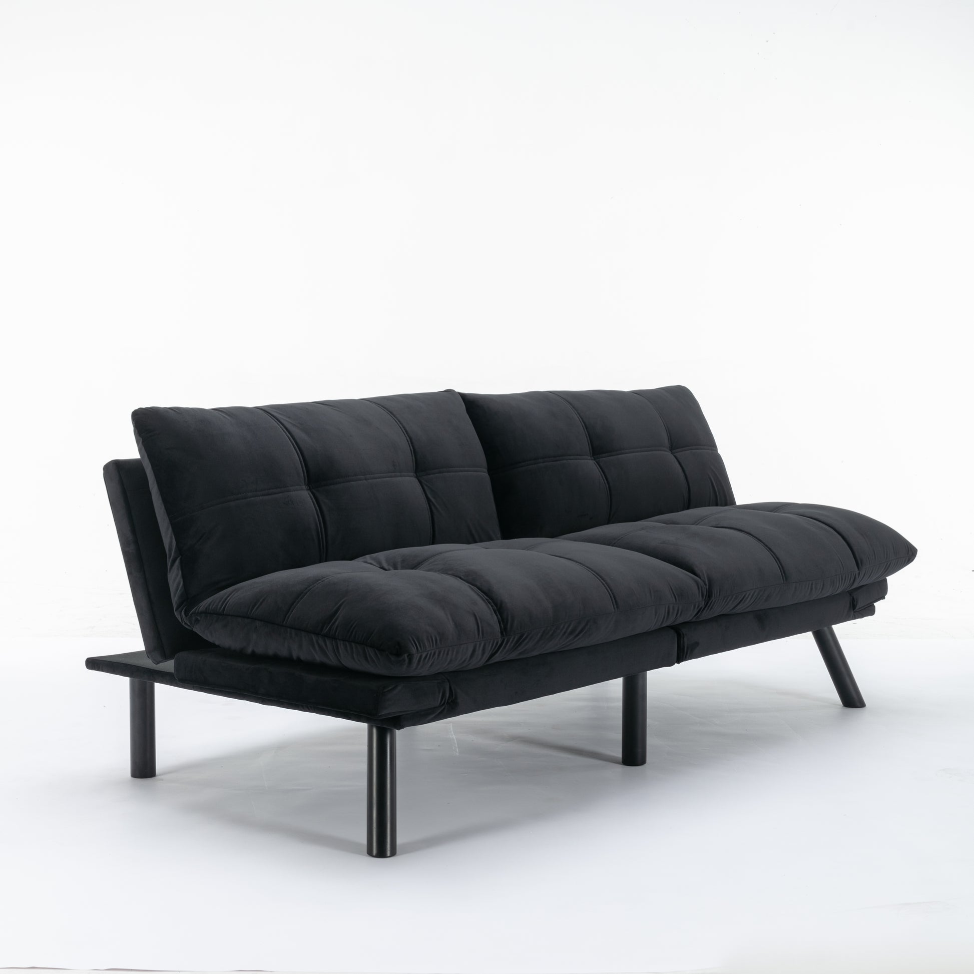 Black velvet convertible sofa with tufted cushions and dark metal legs