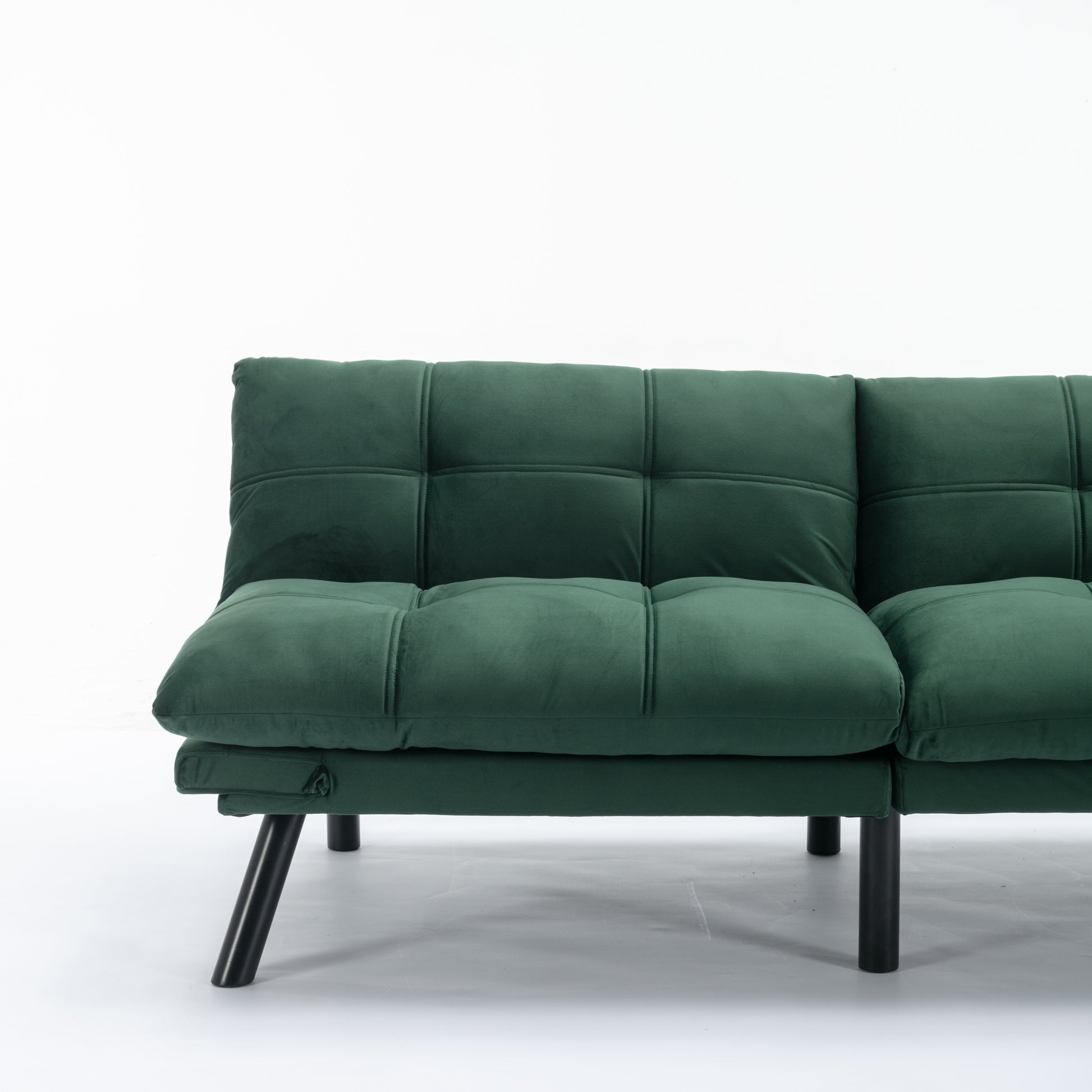 Deep emerald velvet sofa with tufted cushions and black metal legs perfect for modern living rooms
