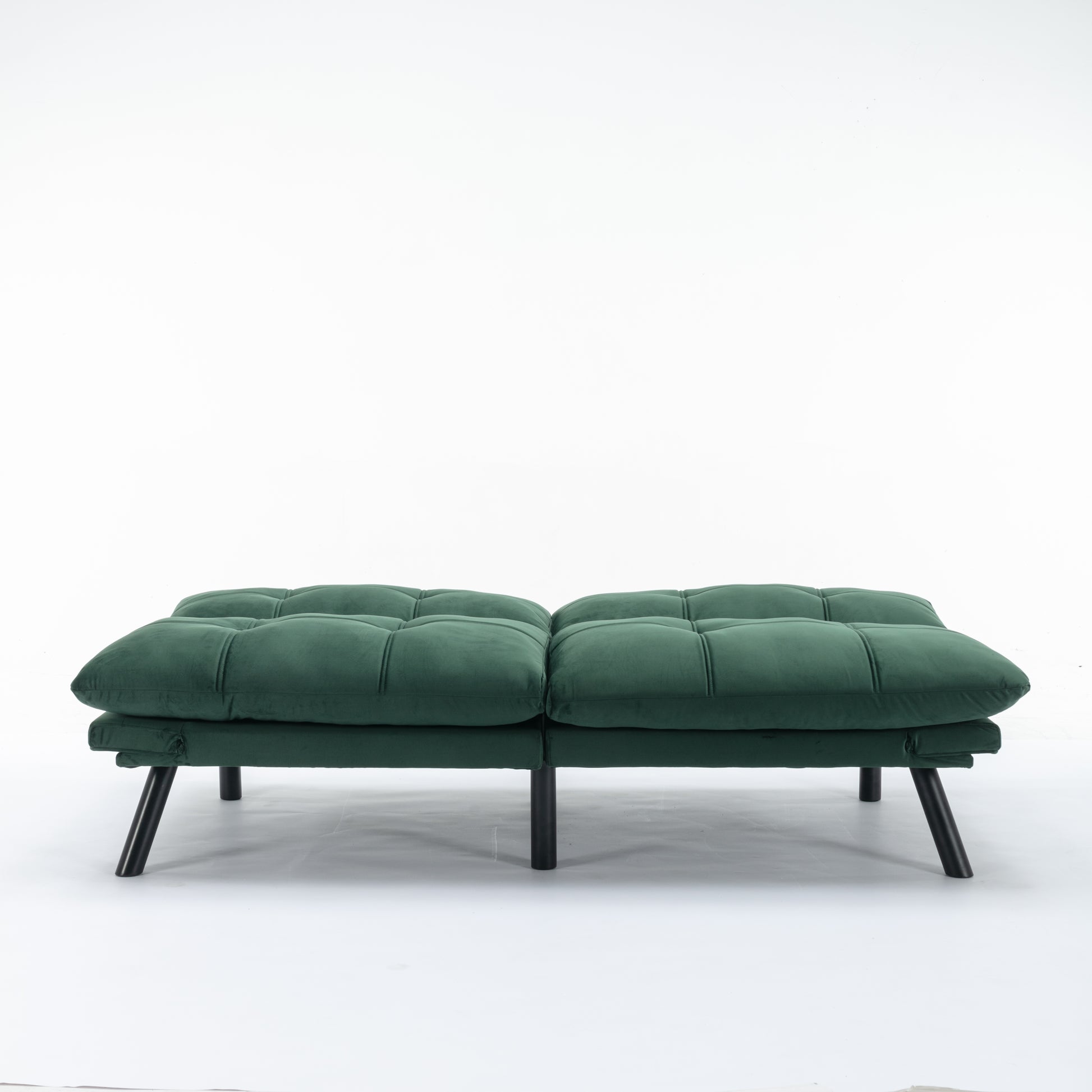 Emerald green velvet futon sofa with tufted cushions and black metal legs