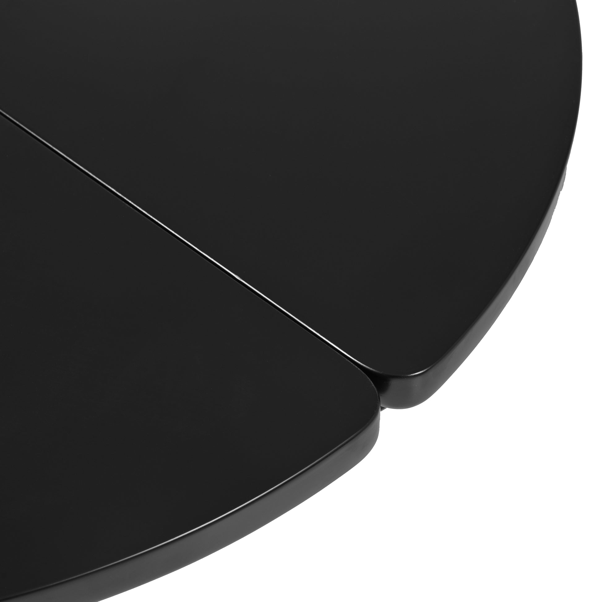 Closeup of a black round table with a seamless finish