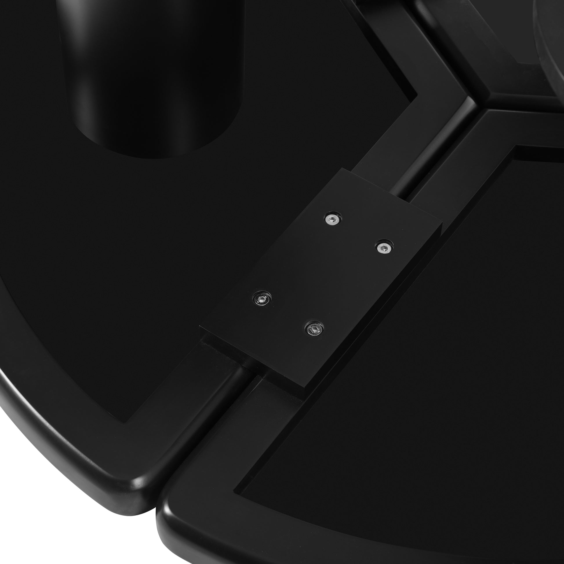 Closeup of black plastic tray with hexagonal inserts and silver screws