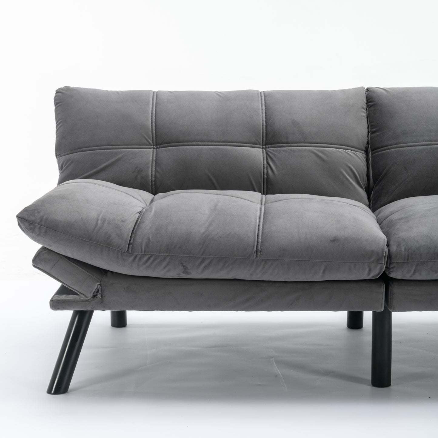Gray velvet futon sofa with tufted cushions and black metal legs