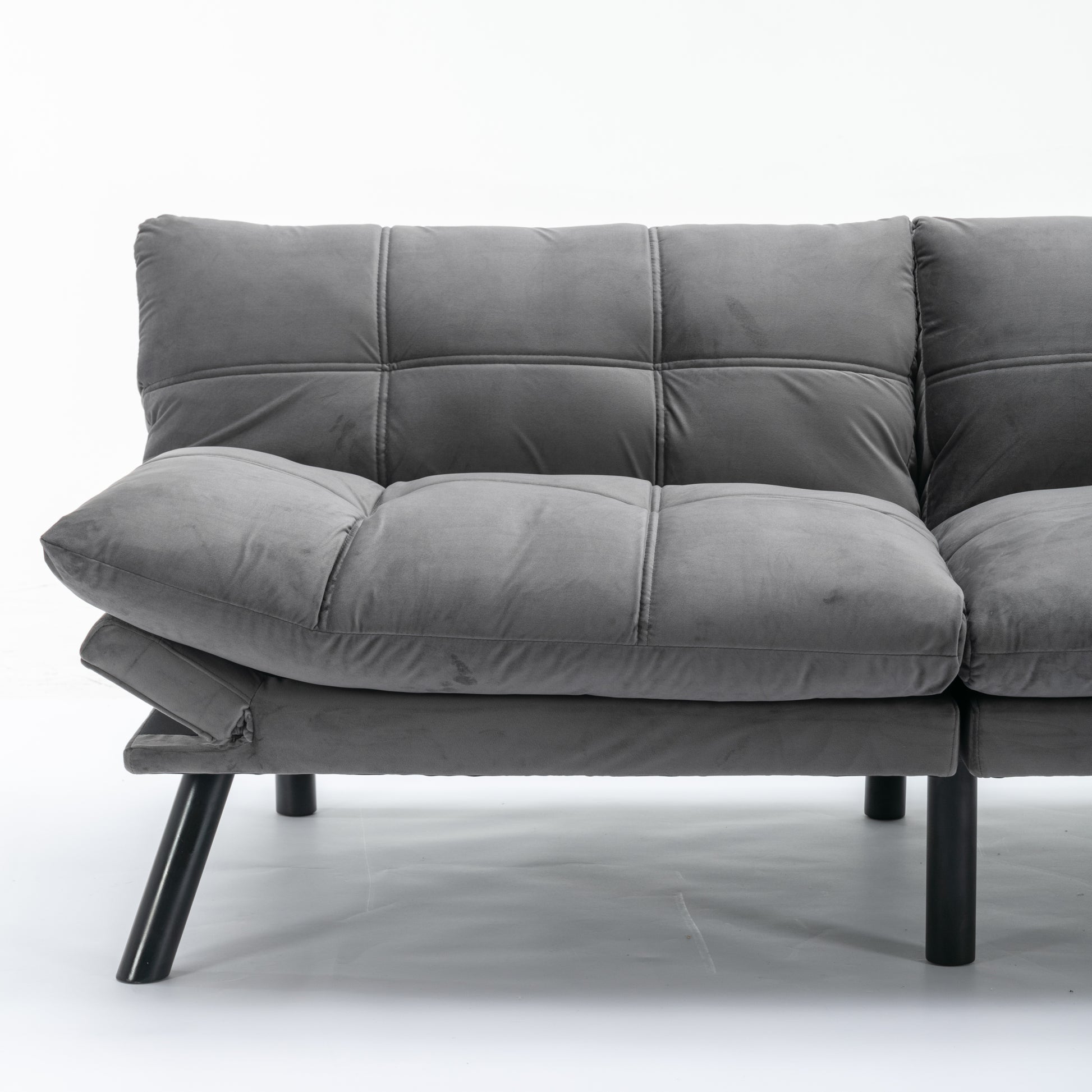 Gray velvet futon sofa with tufted cushions and black metal legs