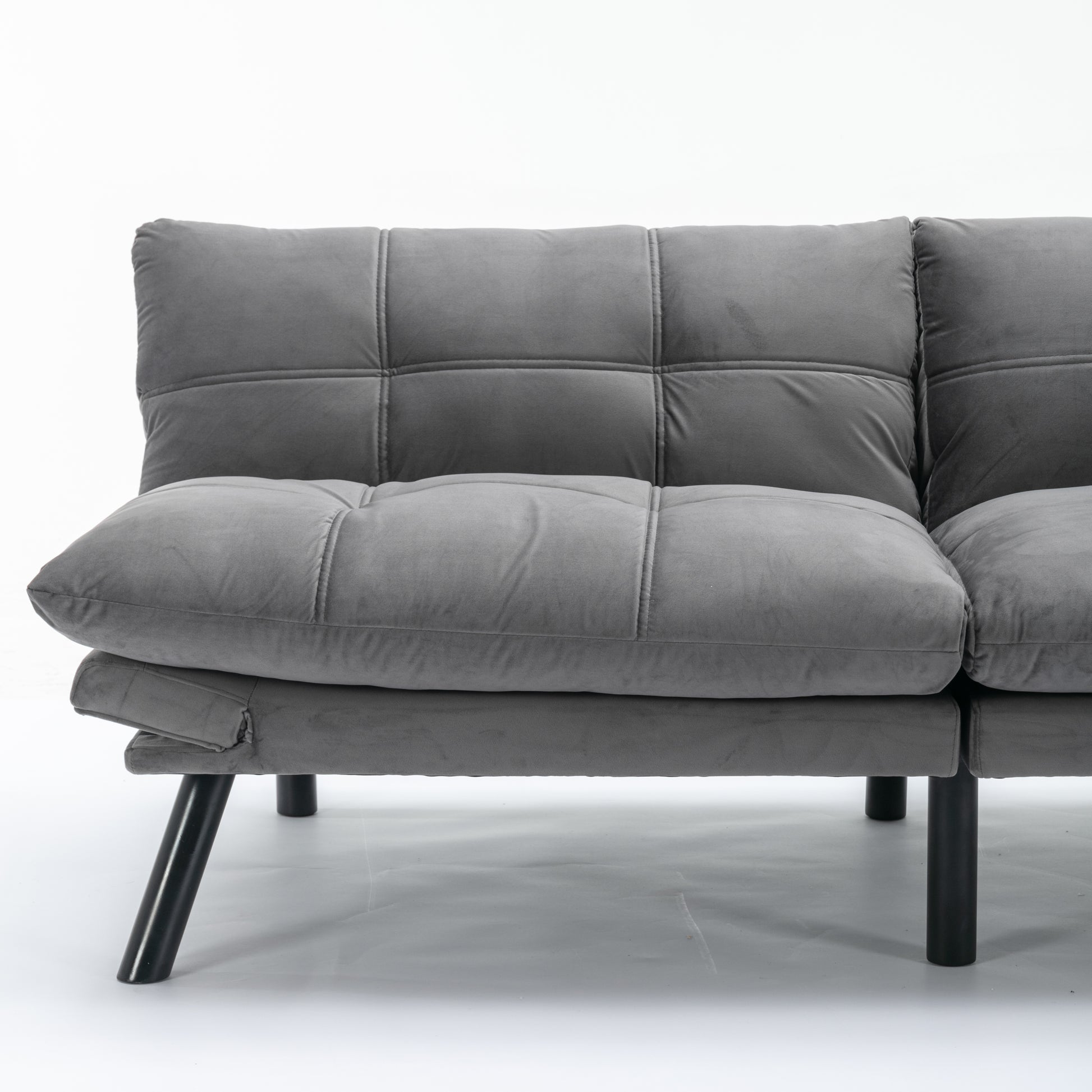 Gray velvet futon sofa with tufted cushions and modern black legs