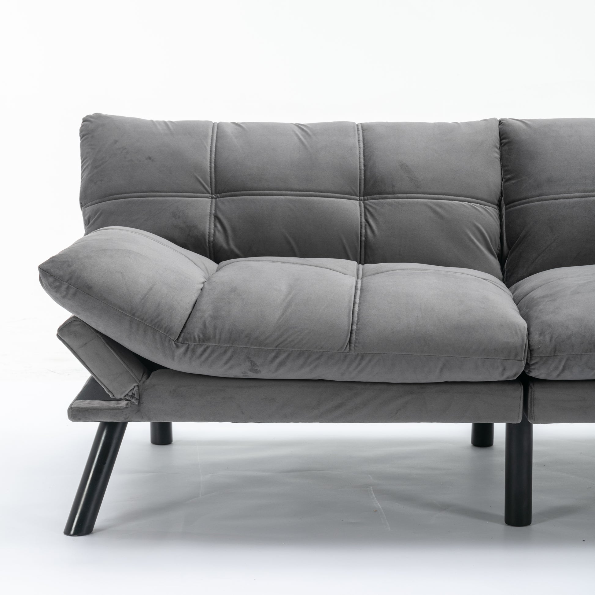 Plush grey velvet sofa with tufted cushions and modern black legs