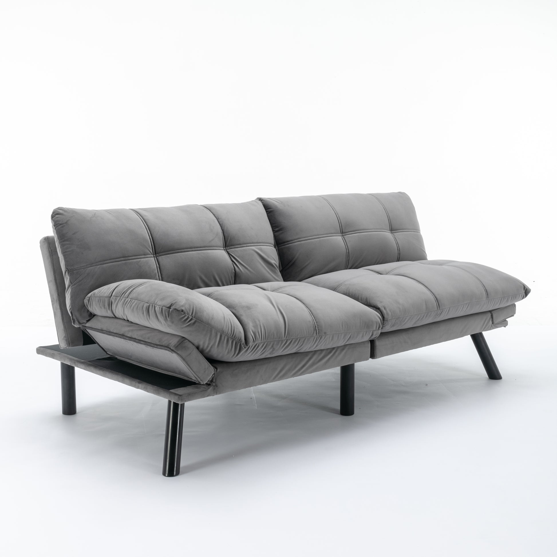 Grey velvet convertible sofa with tufted cushions and black metal legs