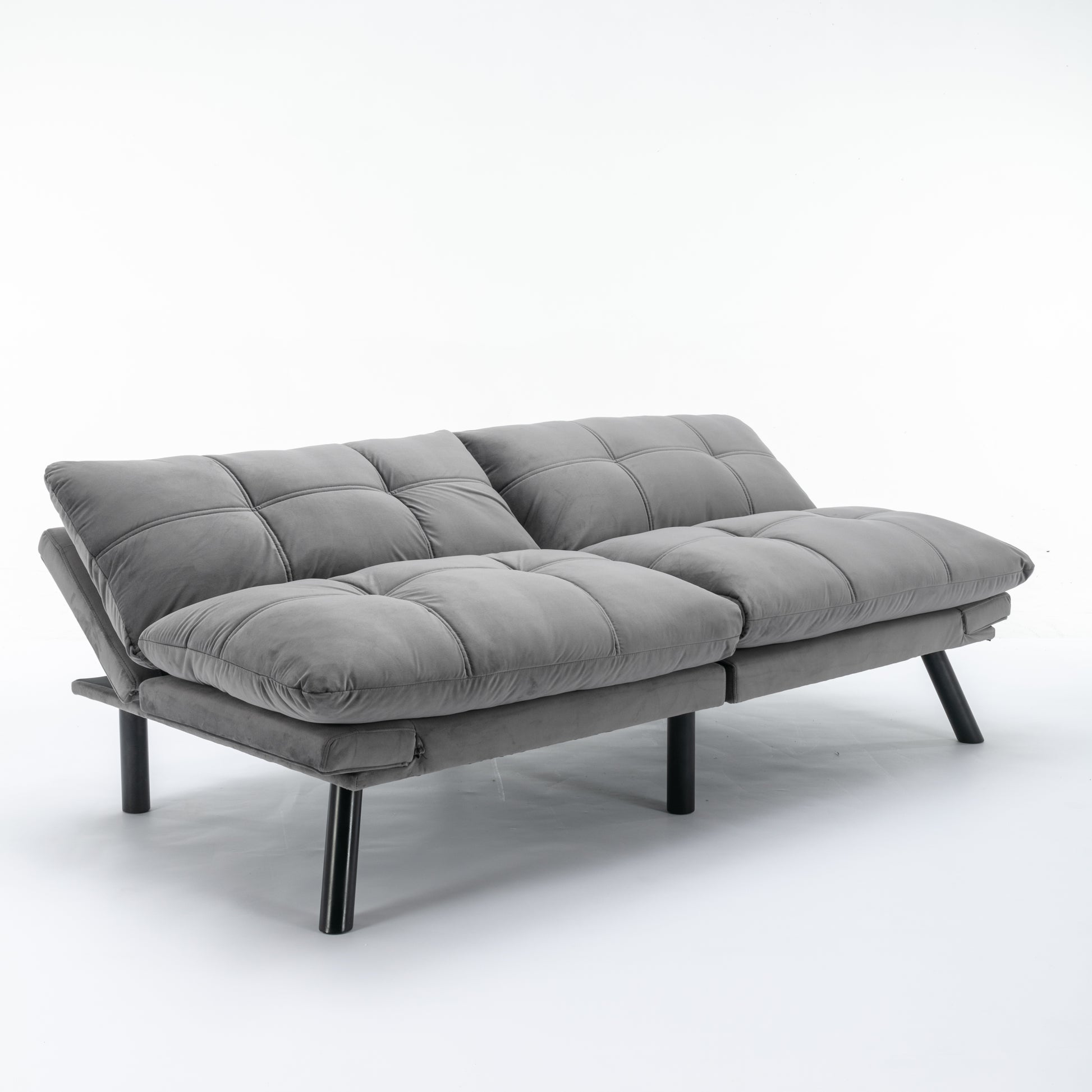Grey velvet sofa with tufted cushions and black metal legs