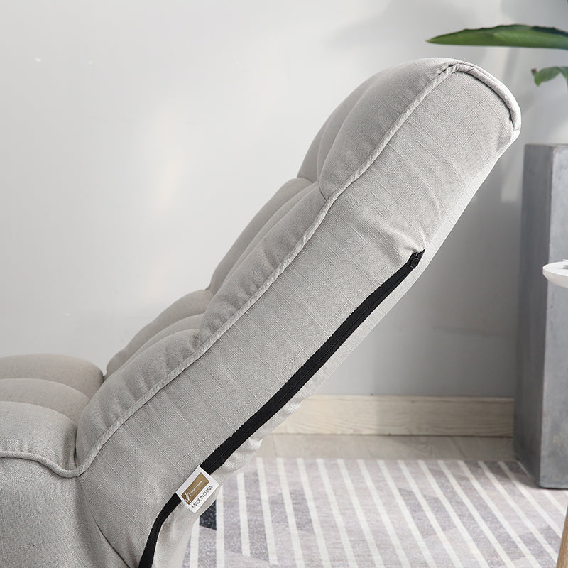 Light gray upholstered adjustable lounge chair with tufted cushioning for comfortable relaxation