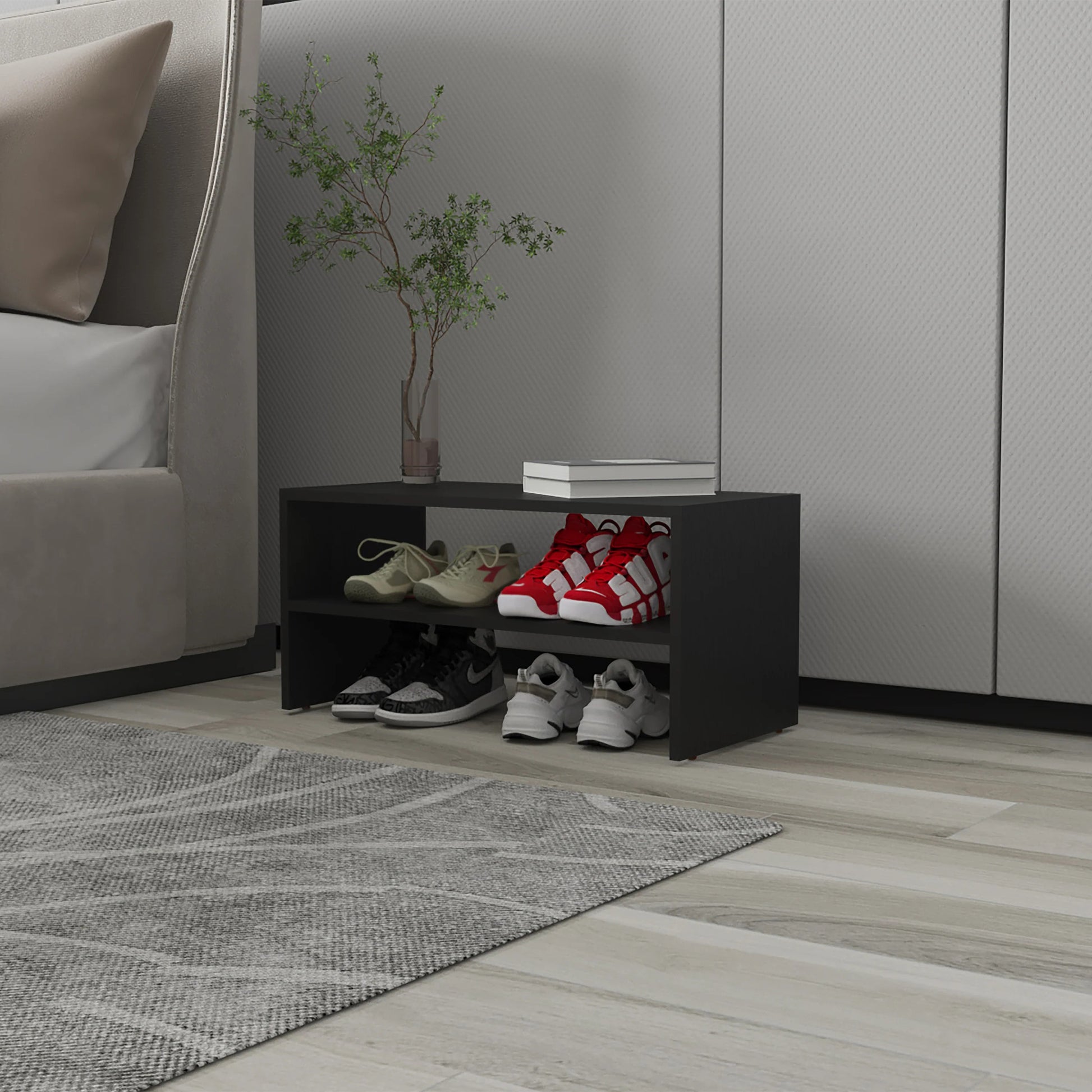 Black tier shoe rack with tan and red athletic shoes