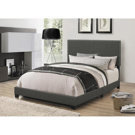 Charcoal fabric upholstered bed frame with a buttontufted headboard and sturdy wooden legs