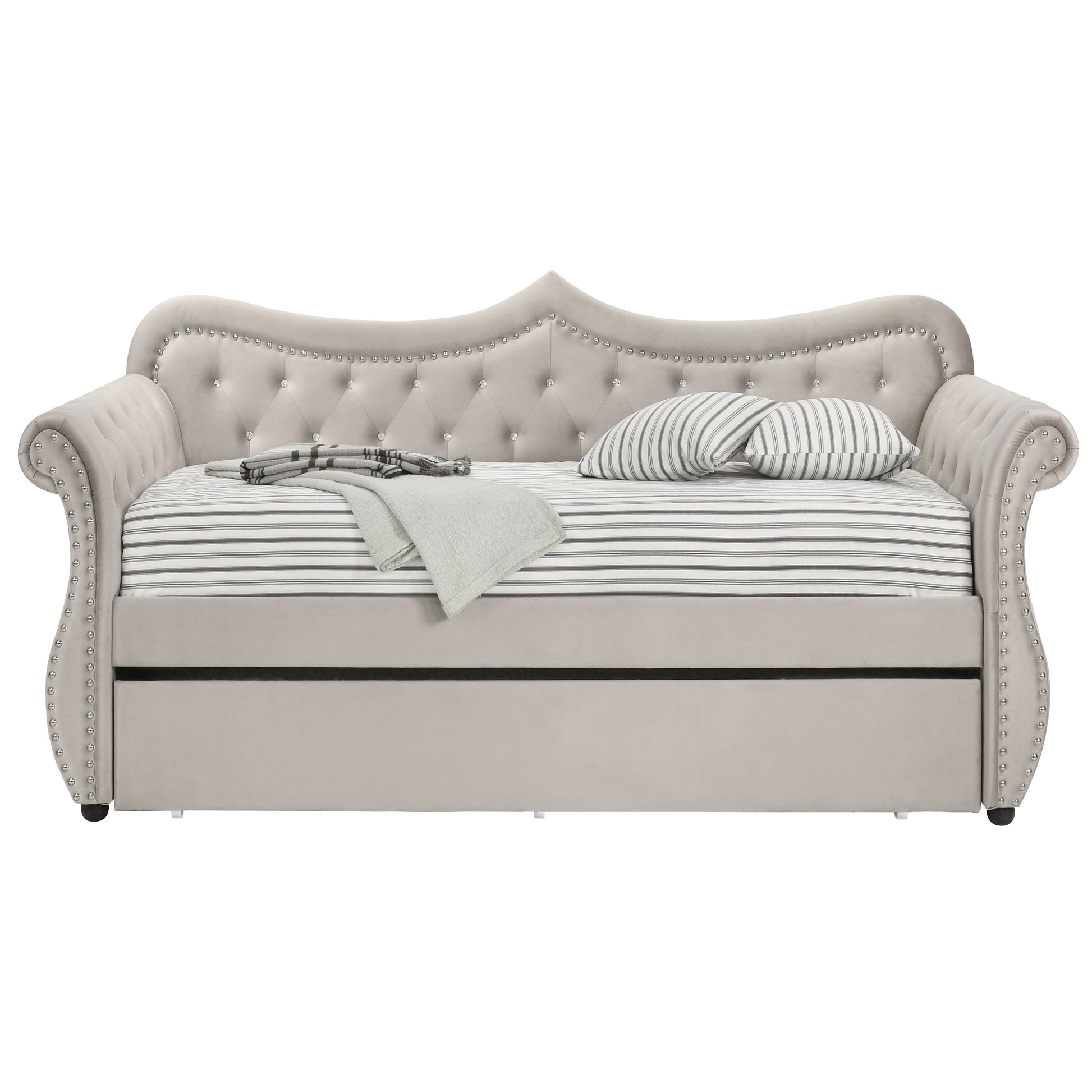 Elegant grey velvet daybed with tufted back and rhinestone accents featuring a pullout trundle bed for guests