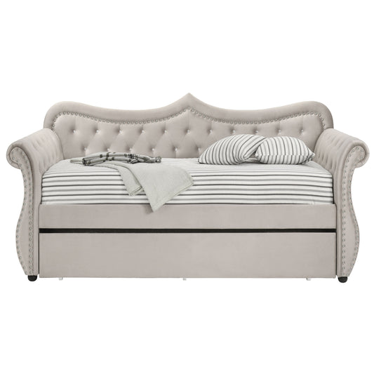 Elegant grey velvet daybed with tufted back and rhinestone accents featuring a pullout trundle bed for guests