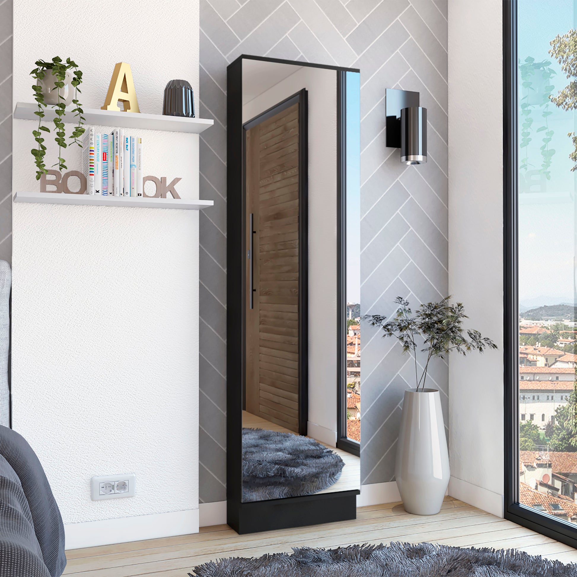 Tall black framed full length mirror reflecting a wooden door