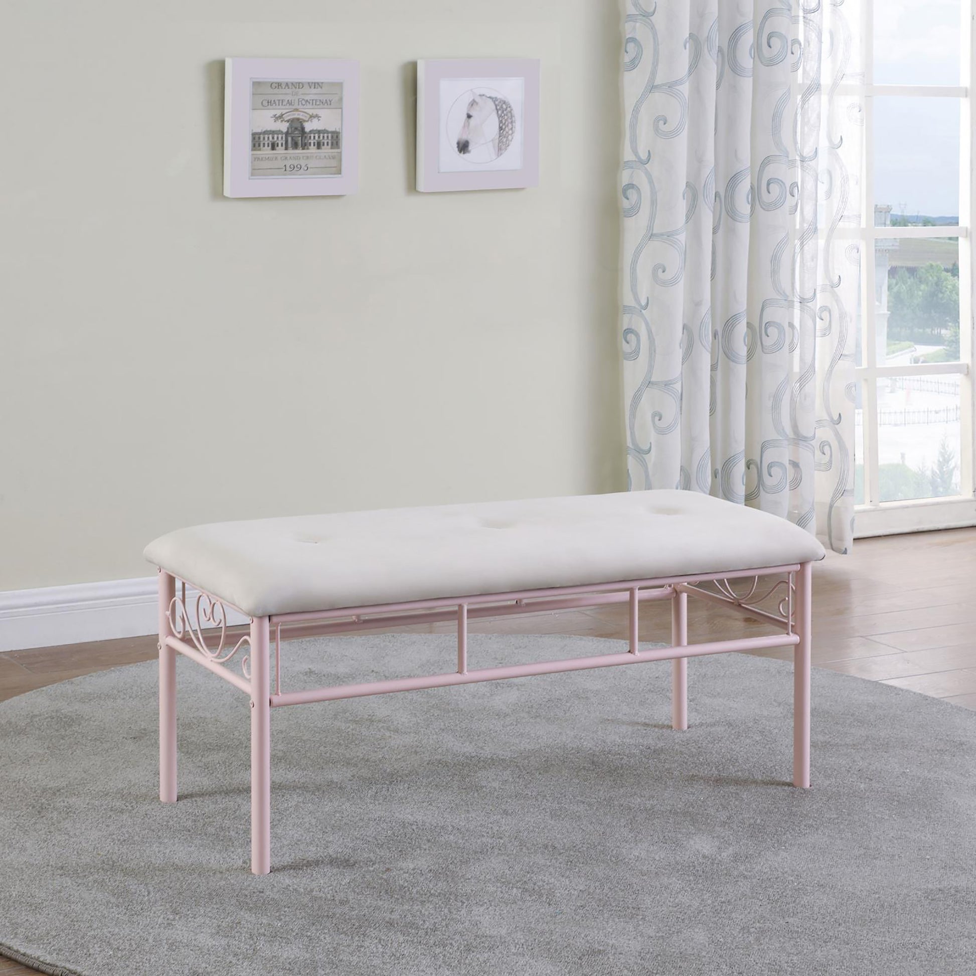 Tufted white upholstered bench with pink metal scrollwork frame perfect for entryway accent