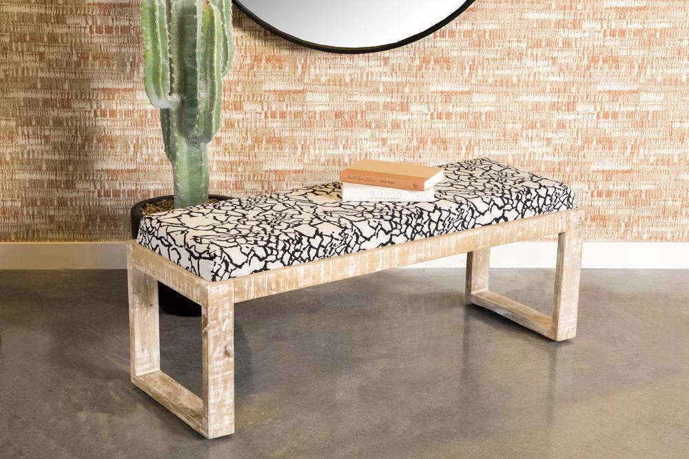 Distressed wood bench with black and white abstract patterned upholstered seat