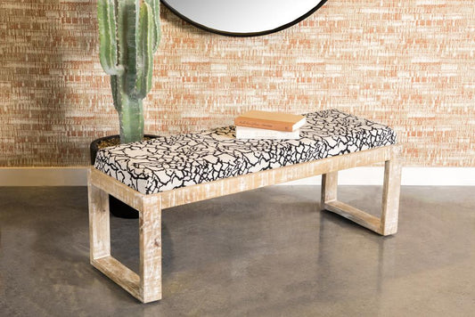 Distressed wood bench with black and white abstract patterned upholstered seat