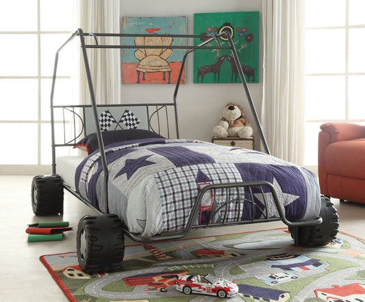 Boys race car bed frame with a starpatterned quilt featuring black wheels