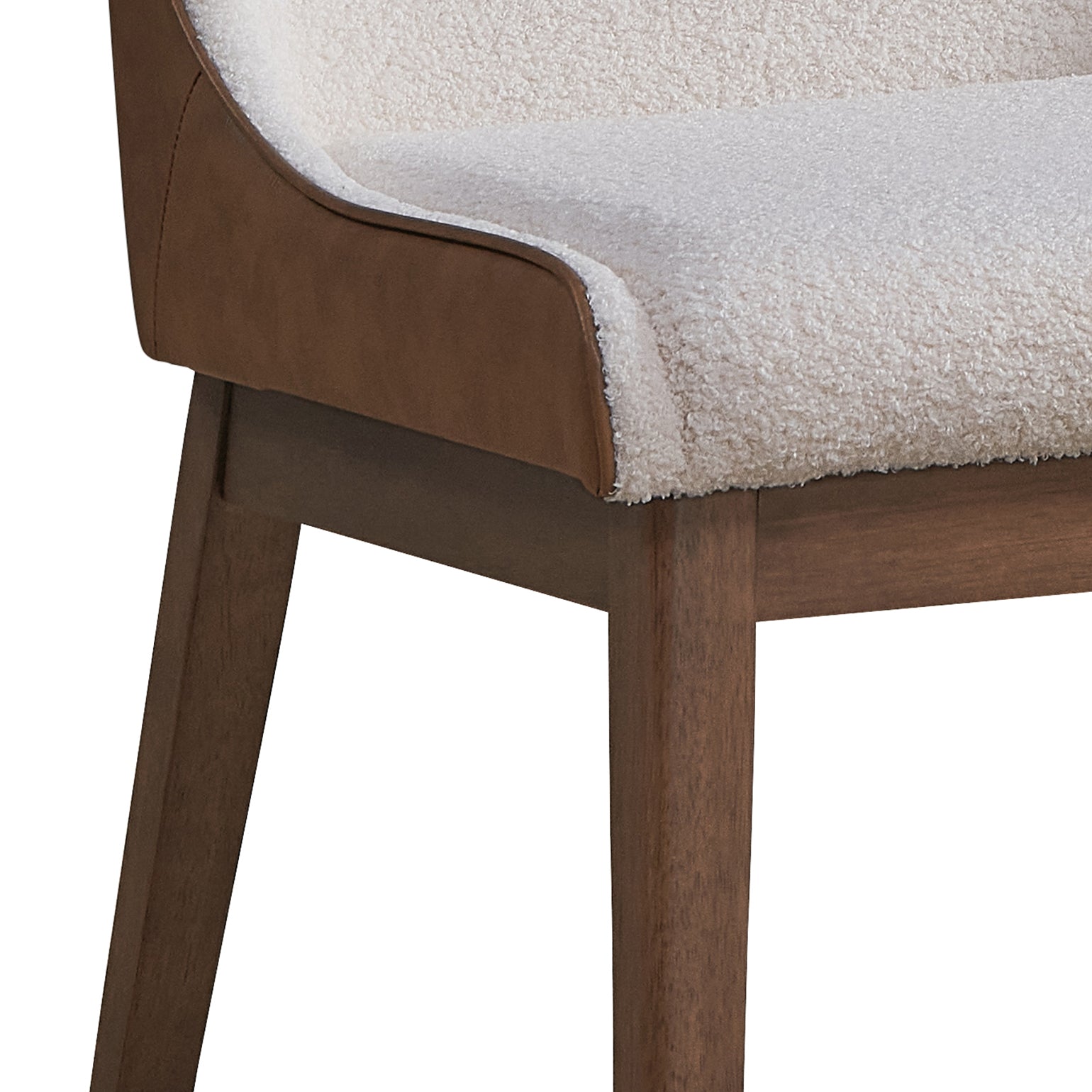 Cream boucle upholstered accent chair with brown leather trim and dark wood legs