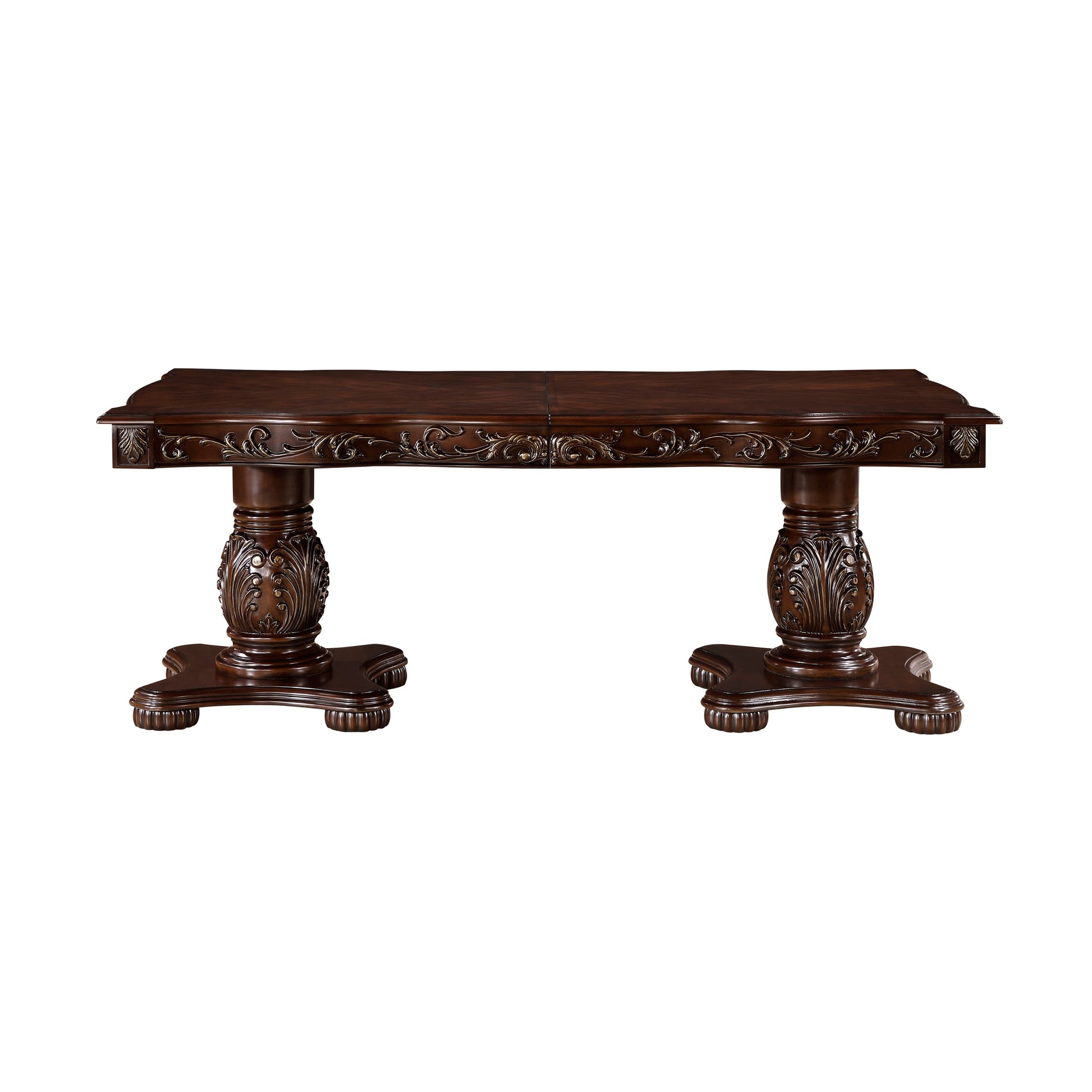 Ornate dark wood dining table with carved pedestals and detailed trim