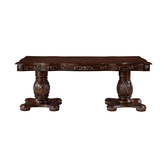 Ornate dark wood dining table with carved pedestals and detailed trim