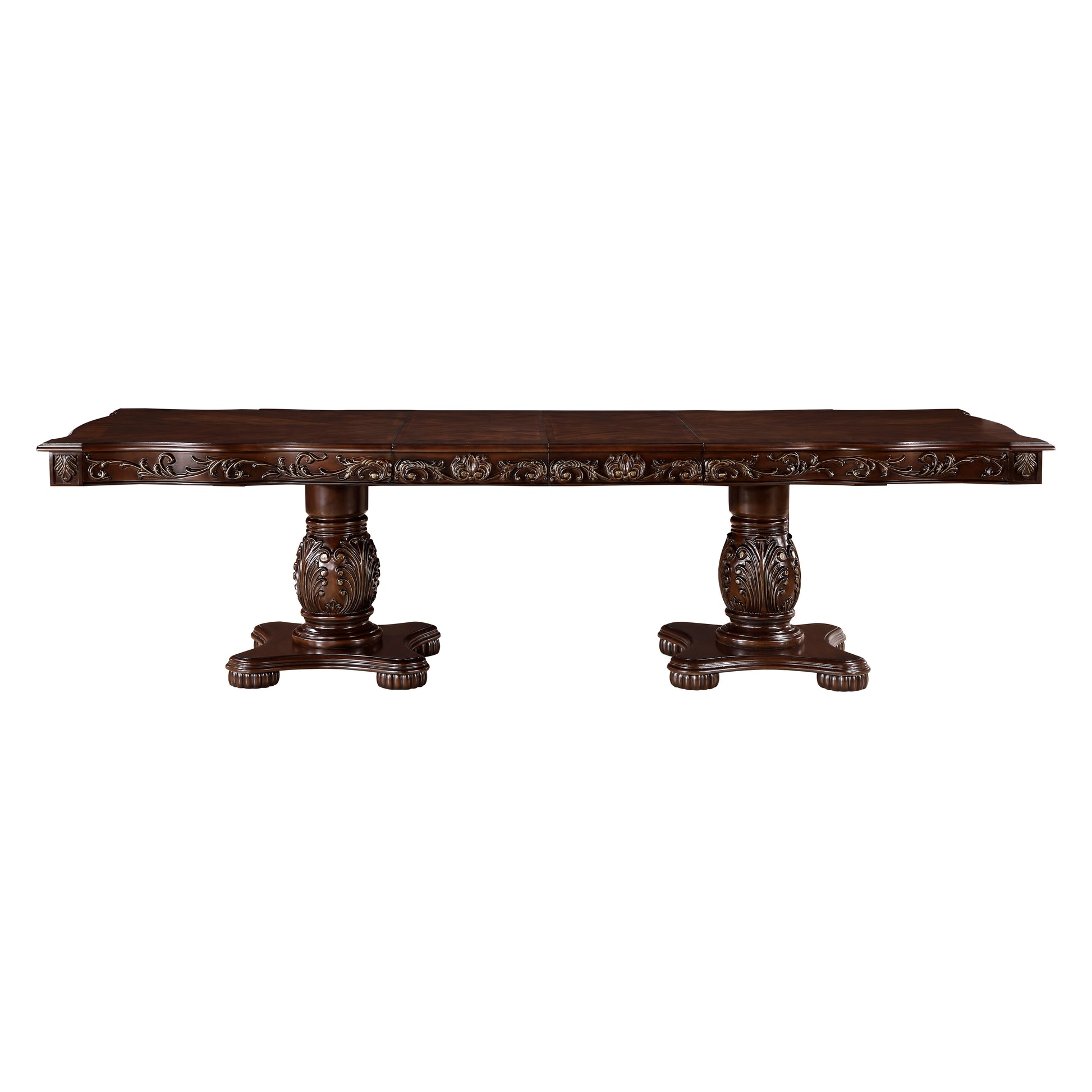 Ornate dark wood dining table with carved pedestal legs and detailed apron trim