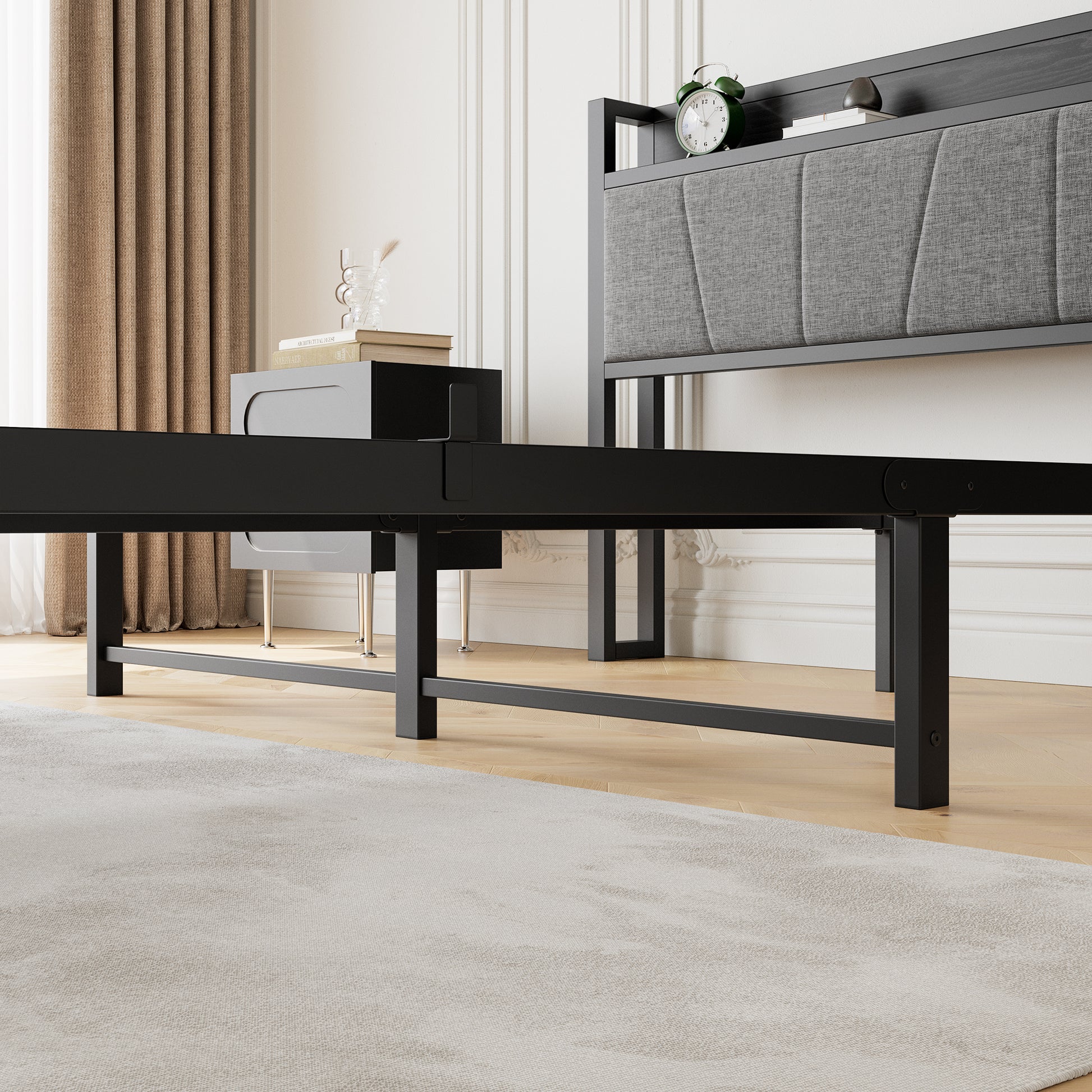 Black metal platform bed frame with grey upholstered headboard