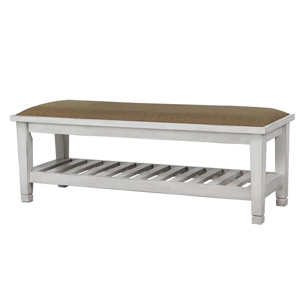 Distressed white wood bench with brown upholstered seat and slatted shelf
