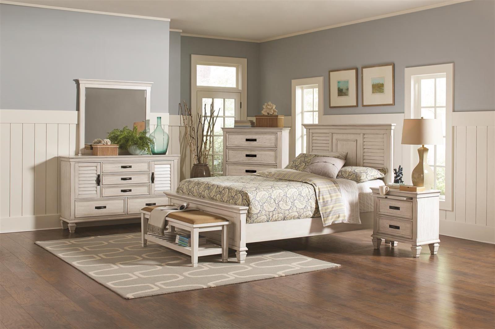White distressed wood bedroom set with paneled headboard and matching dresser