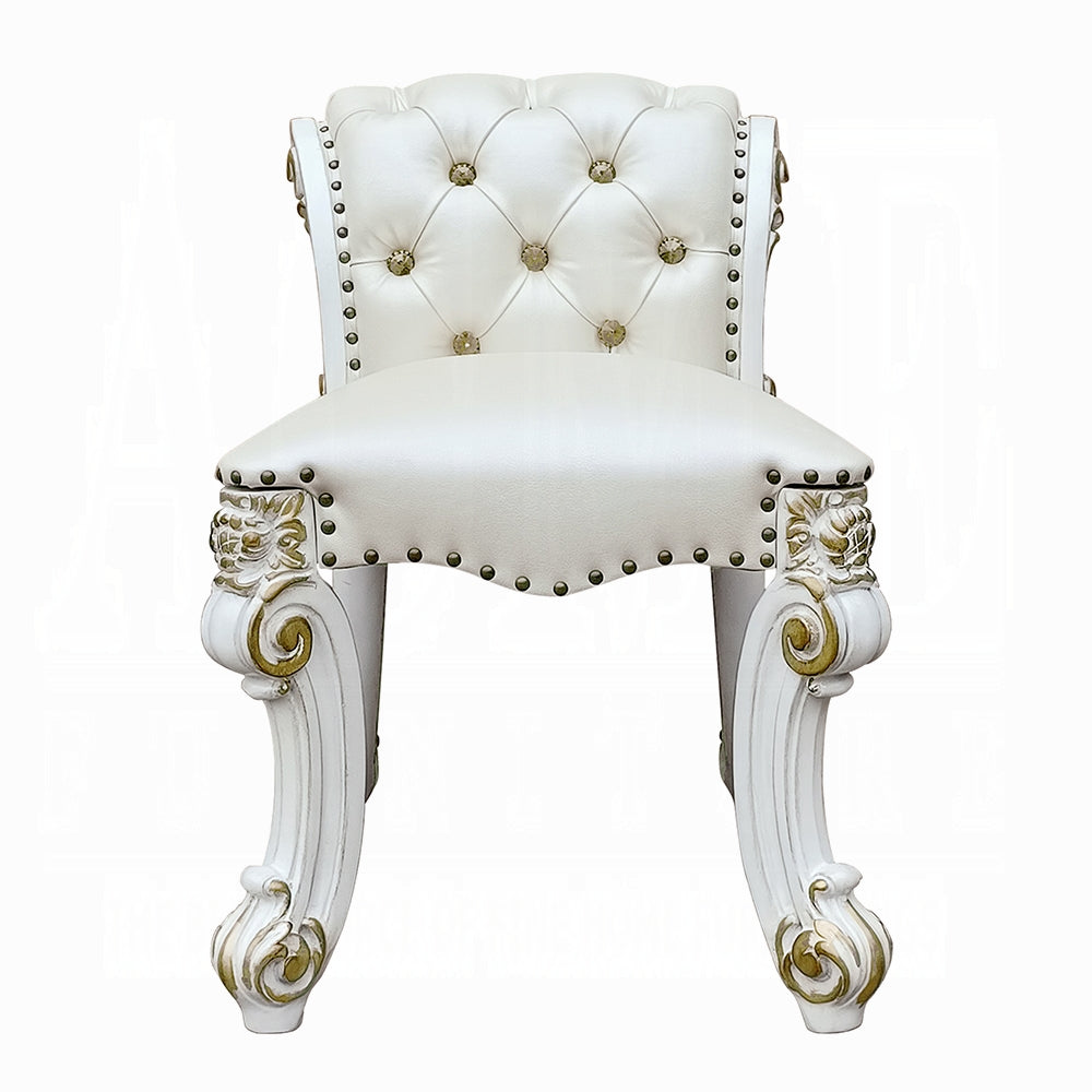 White tufted vanity stool with gold ornate legs and brass nailhead trim