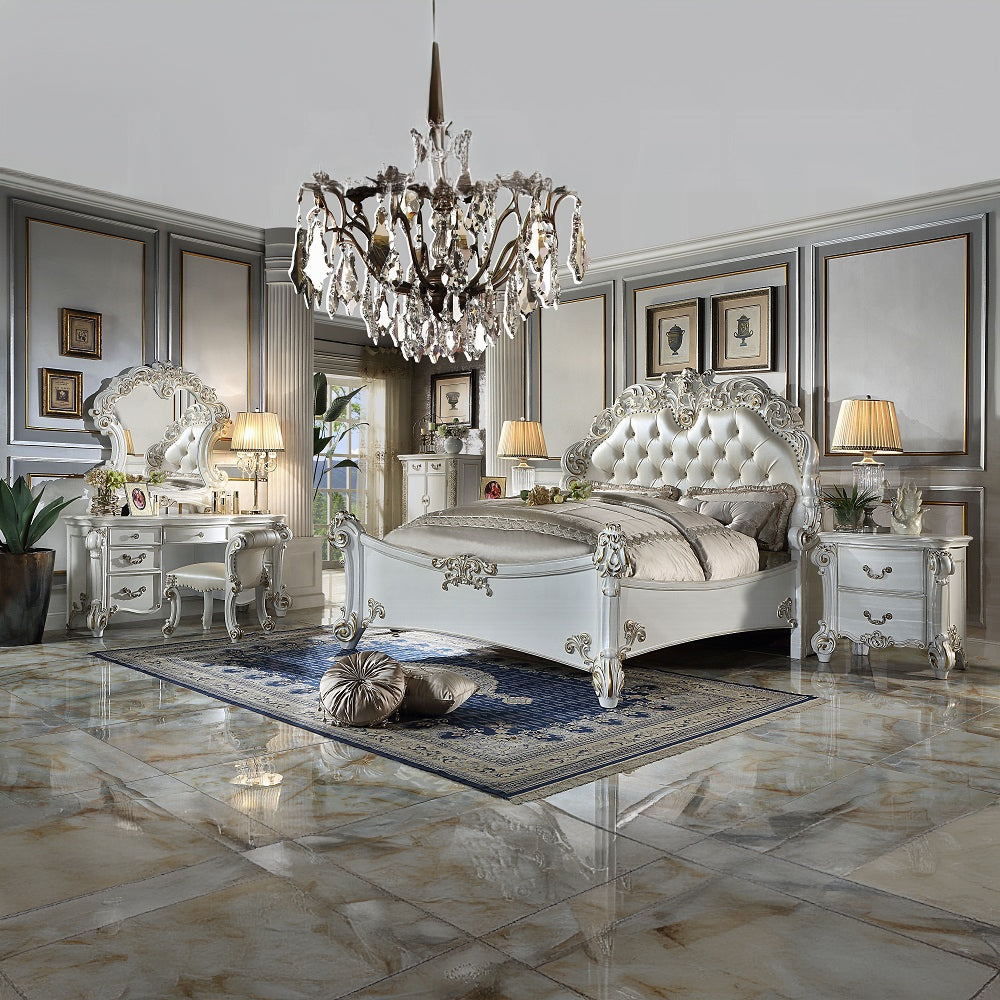 White tufted sleigh bed with ornate gold detailing a statement piece for a luxurious bedroom