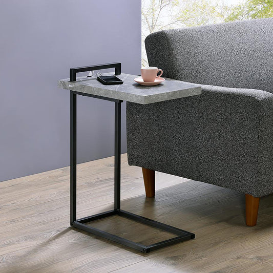 Grey faux marble C table with black metal frame beside a sofa