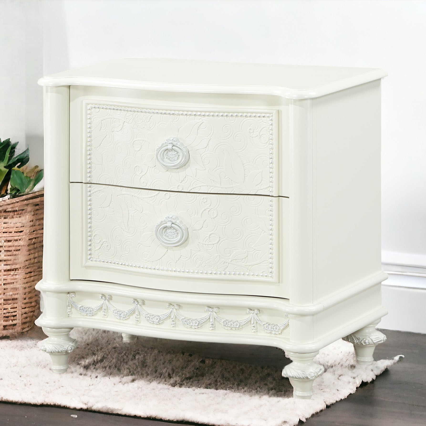 Ornate ivory bedside table with embossed floral design and ornate pulls