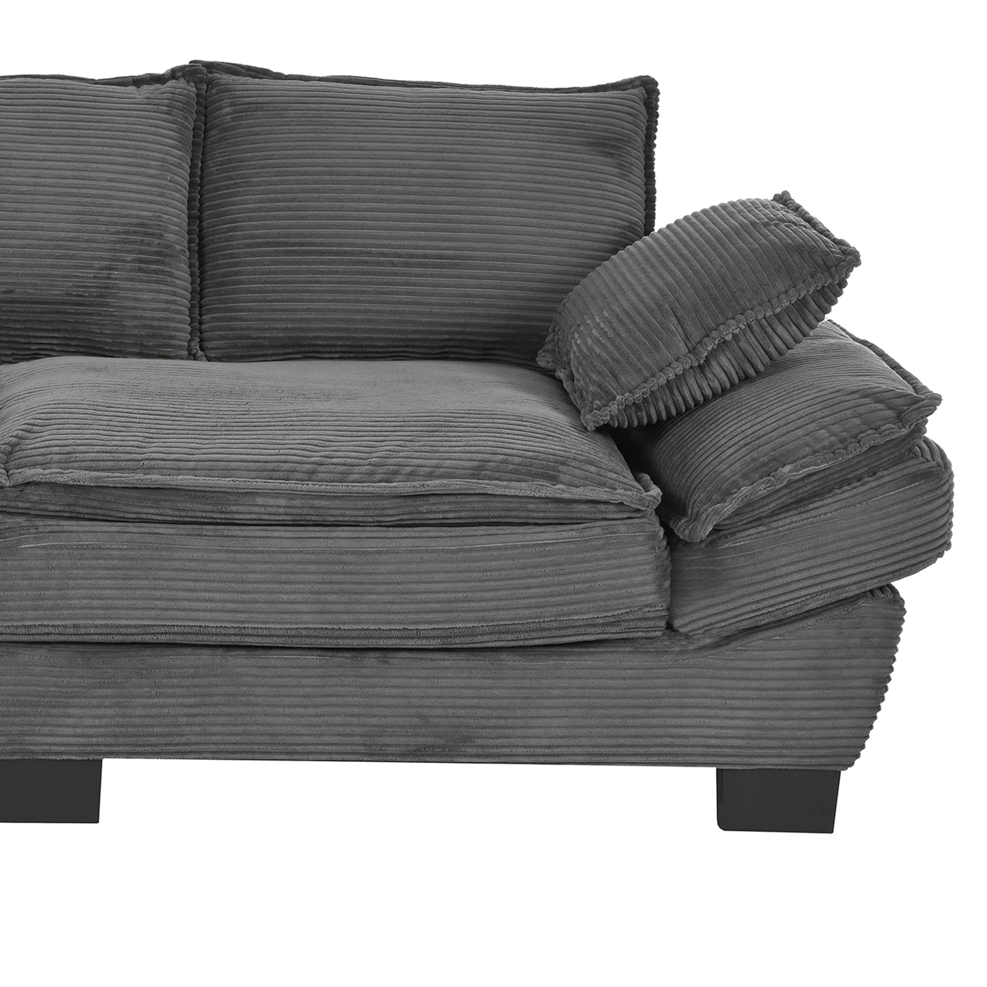 Closeup of a charcoal grey corduroy sofa with plush cushions and square legs