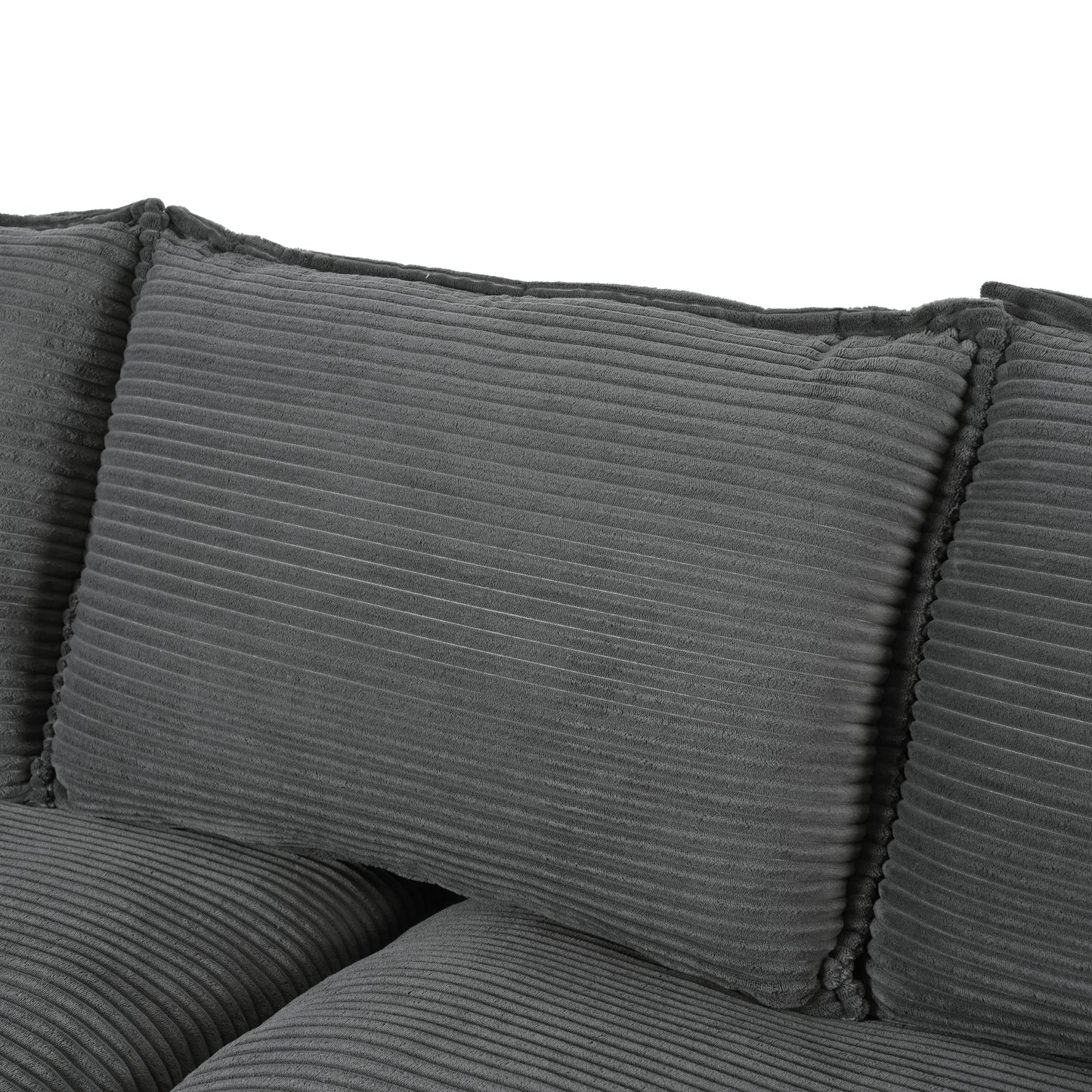 Closeup of a textured grey corduroy sofa with plush cushions