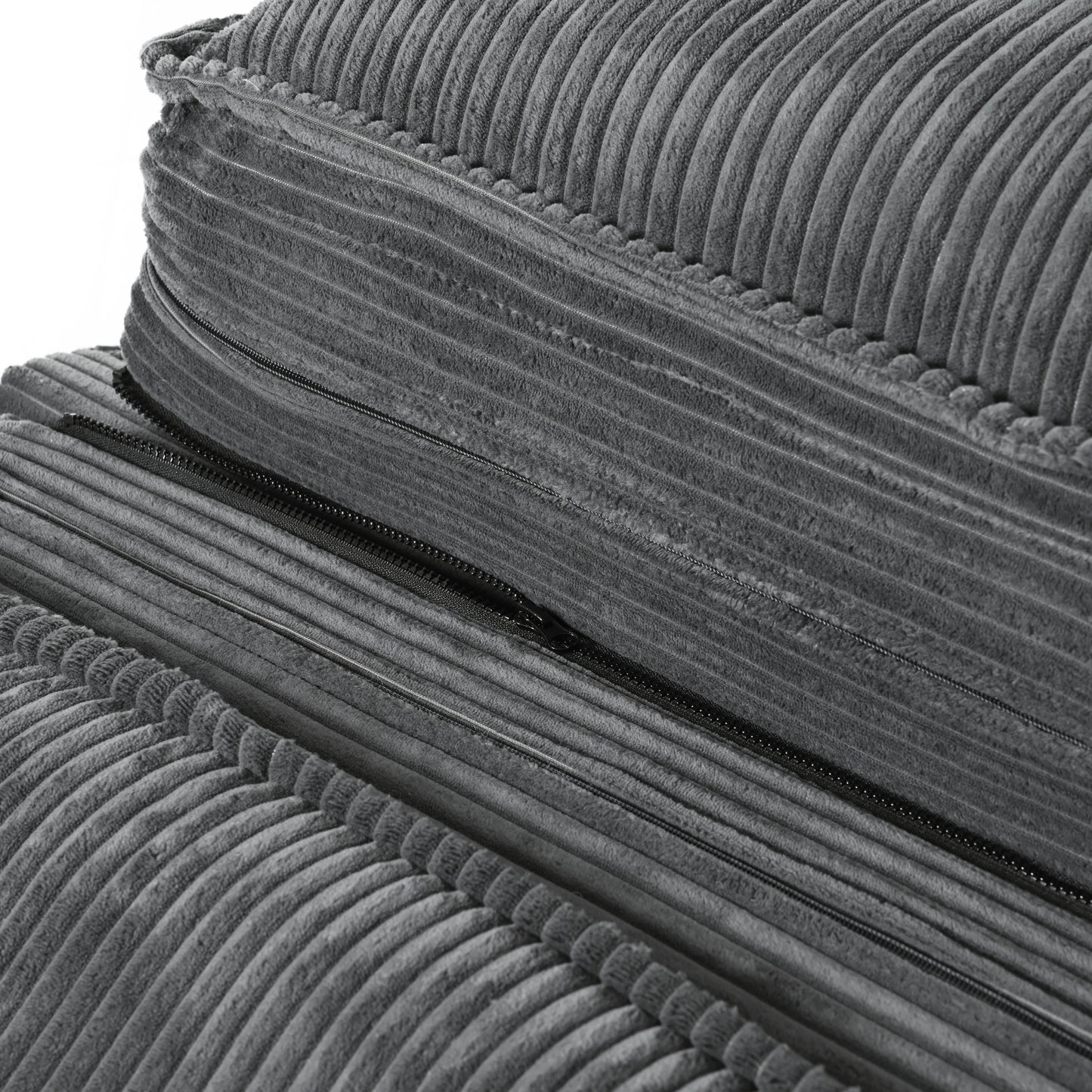 Closeup of dark grey corduroy fabric cushion with exposed black zipper detail