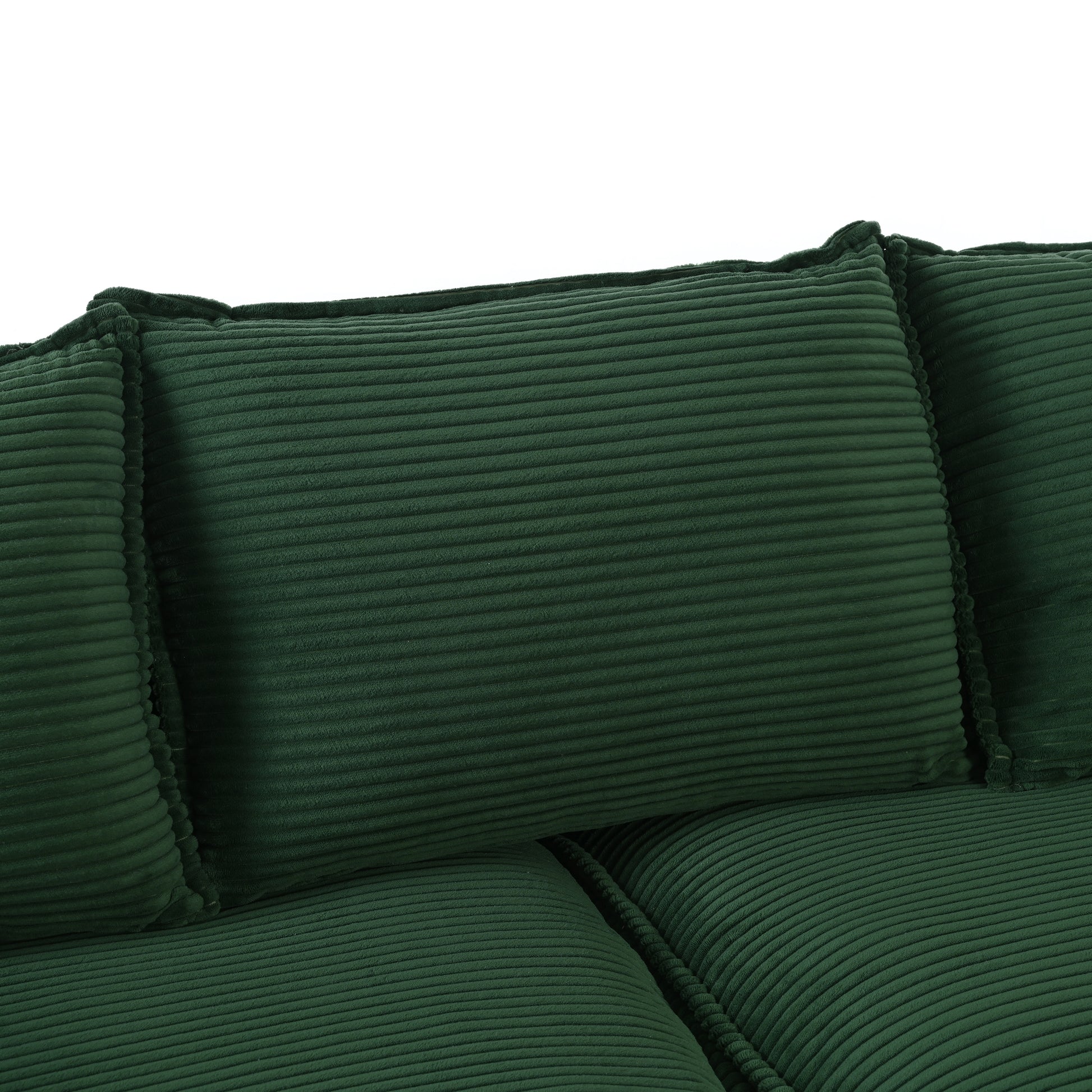 Deep green corduroy sofa with plush textured cushions for ultimate comfort