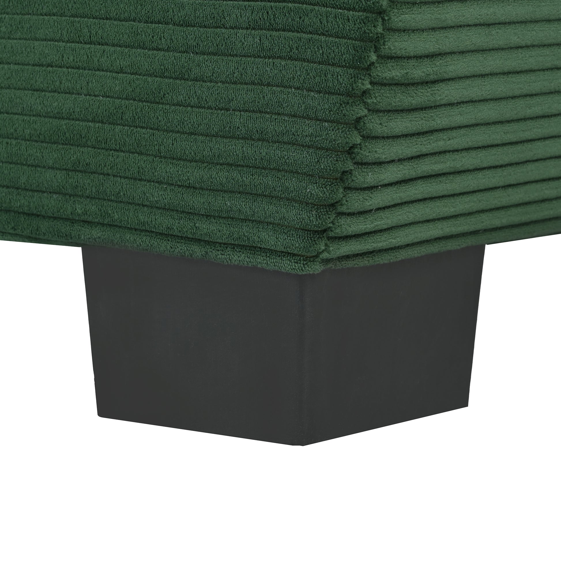 Dark green corduroy sofa cushion corner with black rectangular leg